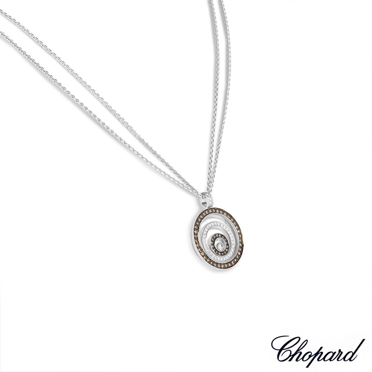 A stylish 18k white gold diamond pendant by Chopard from the Happy Spirit collection. The pendant features three graduating circular motifs set inside each other. The outer and inner circles are pave set with 54 round brilliant cut brown diamonds