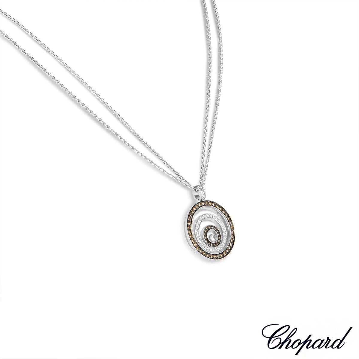 Un élégant pendentif en diamant en or blanc 18 carats de Chopard de la collection Happy Spirit. Le pendentif présente trois motifs circulaires gradués, disposés les uns dans les autres. Les cercles extérieur et intérieur sont sertis de 54 diamants