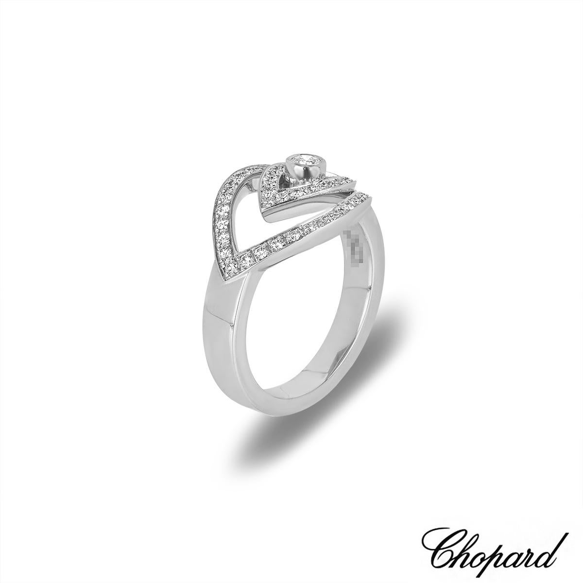 An enticing 18k white gold diamond ring by Chopard from the Happy Spirit collection. The ring features an eye motif set to the centre with a round brilliant cut diamond in a bezel setting, weighing approximately 0.07ct, G colour and VS clarity. The