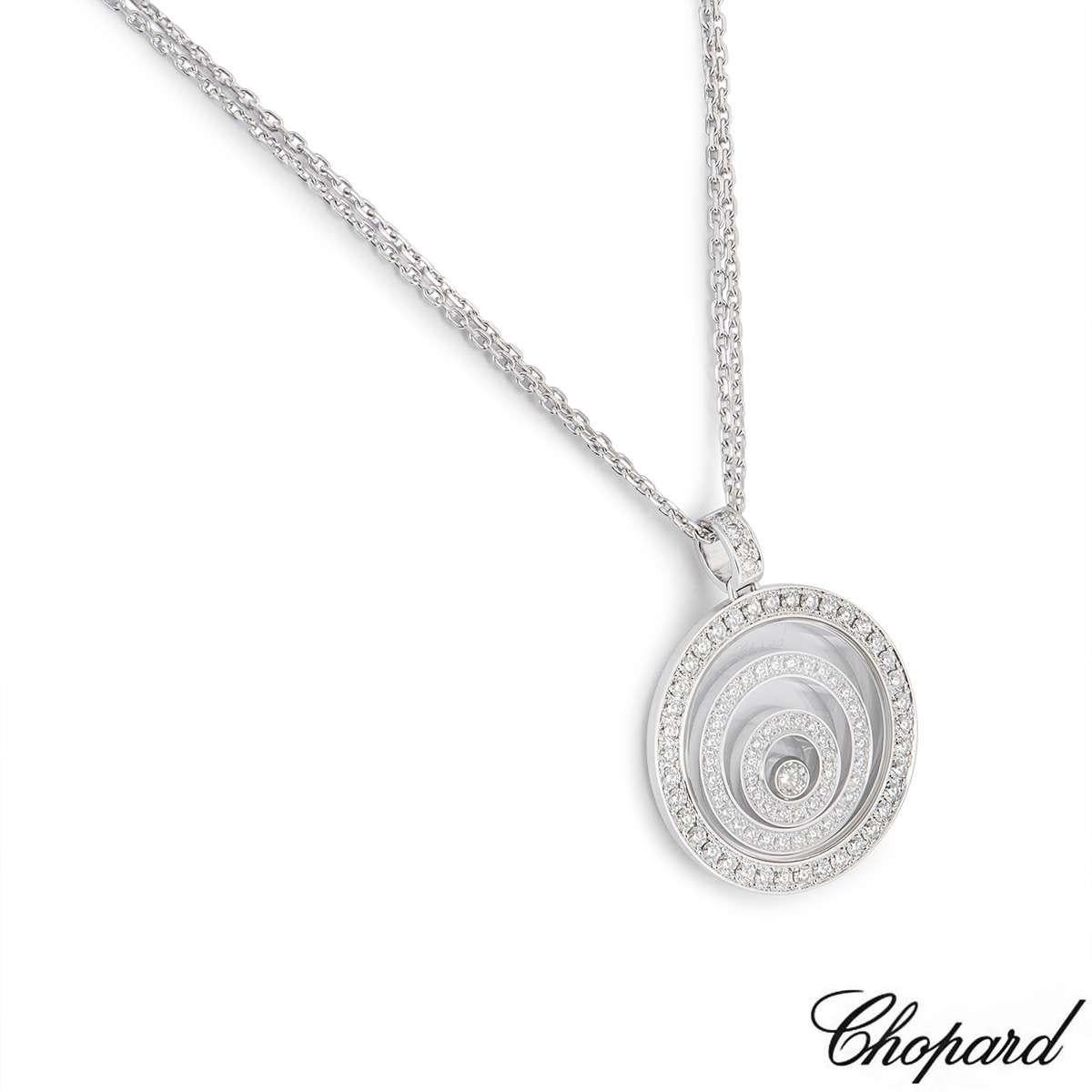 An 18k white gold pendant from the Happy Spirit collection by Chopard. The circular pendant consists of a diamond set bale and outer case with 2 diamond set circular floating motifs, complimented by a single floating diamond in the centre. The