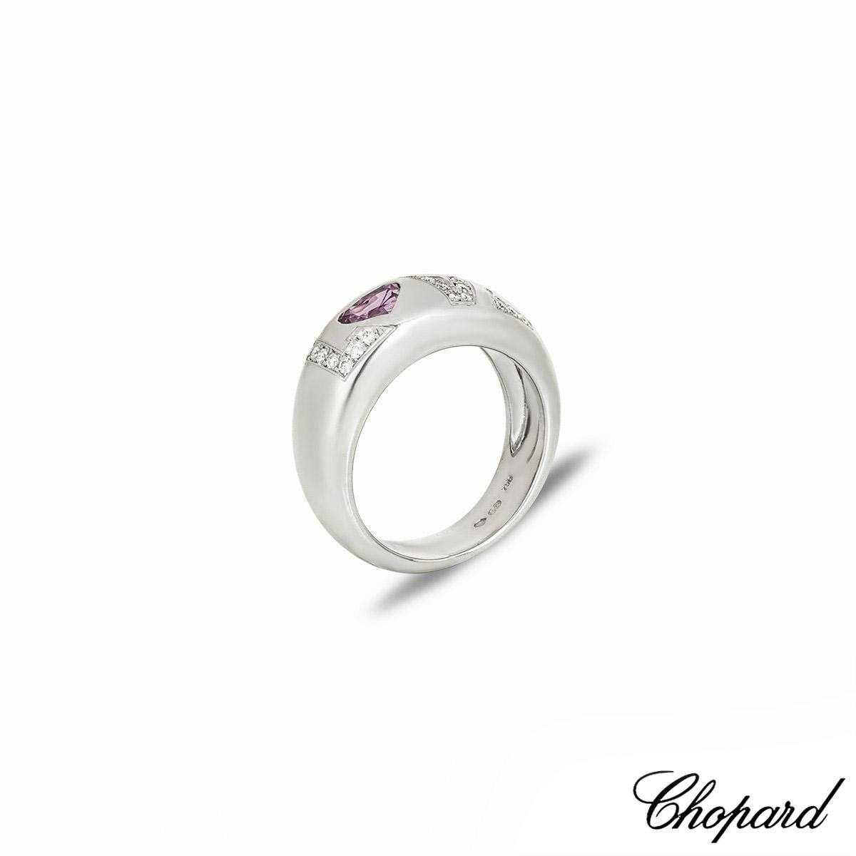 A beautiful 18k white gold pink sapphire and diamond 'Love' ring by Chopard. The ring features the word 'Love' spelt out with a heart shaped pink sapphire as the 'O' and  28 round brilliant cut diamonds totalling approximately 0.24ct, F-G colour and