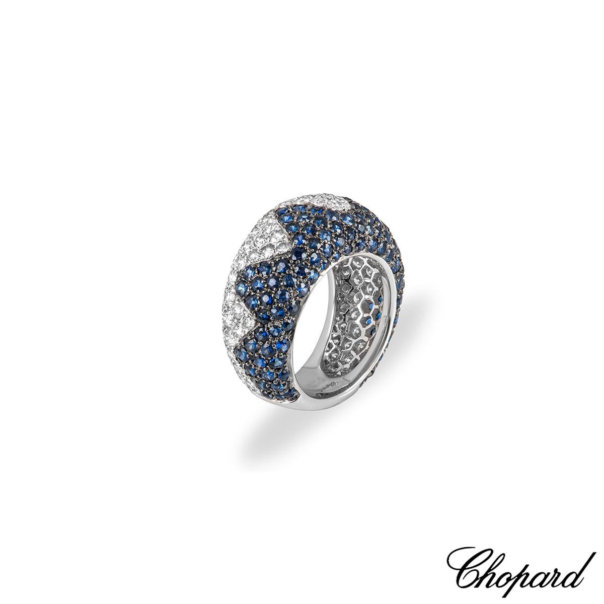 A marvellous 18k white gold sapphire and diamond ring by Chopard. The ring features a zigzag design down the centre set with sapphires and diamonds. Pave set to half the ring are 112 round cut sapphires displaying a deep blue hue, with a total carat