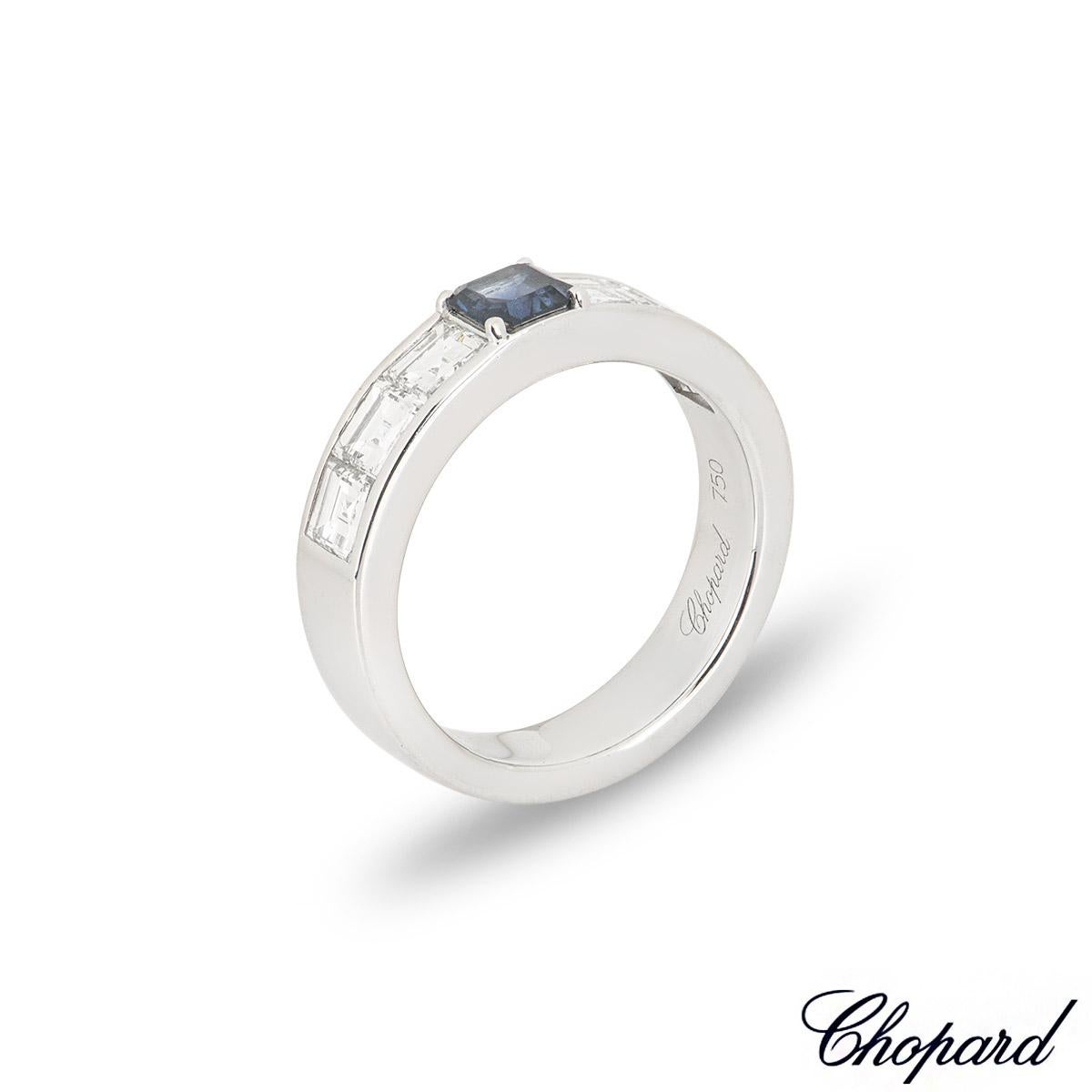 A versatile 18k white gold sapphire and diamond ring by Chopard. The ring is set to the centre with an asscher cut sapphire weighing 0.53ct, displaying a rich blue hue. Complementing the sapphire are 6 asscher cut diamonds channel set to the