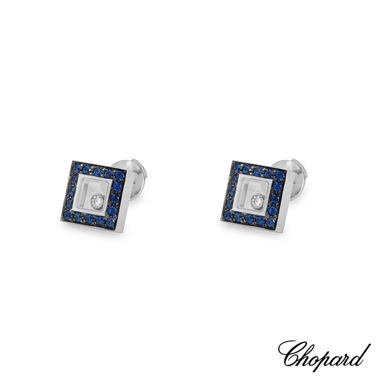 A beautiful pair of 18k white gold Happy Diamonds earrings by Chopard. The earrings feature a square motif set to the centre with a round brilliant cut diamond, floating behind the signature Chopard signed glass, with a total weight of 0.11ct.  Each