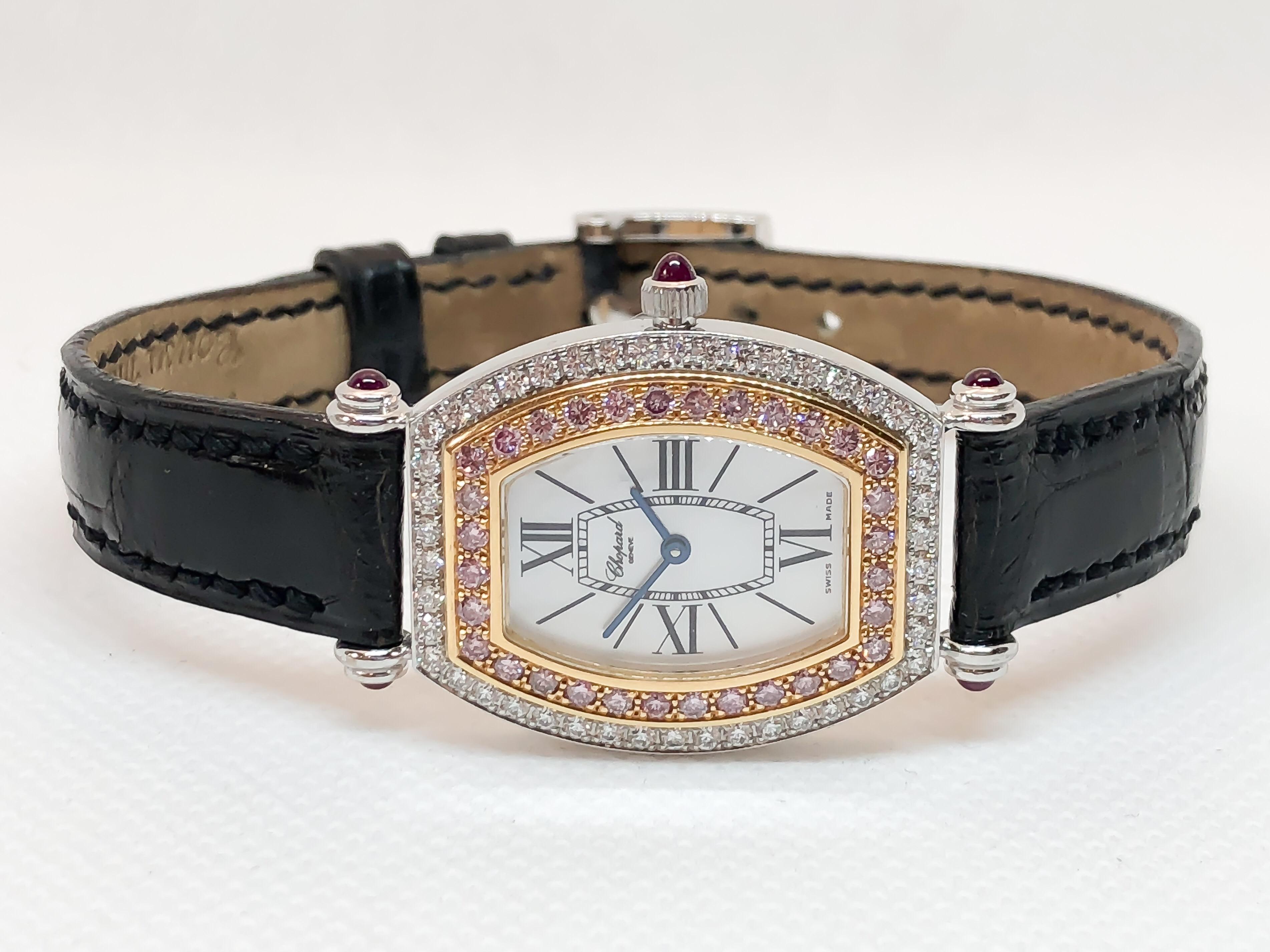 Lovely feminine Chopard watch set with stunning pink and white diamonds in 18 karat rose and white gold. Tonneau shape case attached to a black Chopard leather strap with ruby crown and lug accents. Comes with original box, papers & three extra