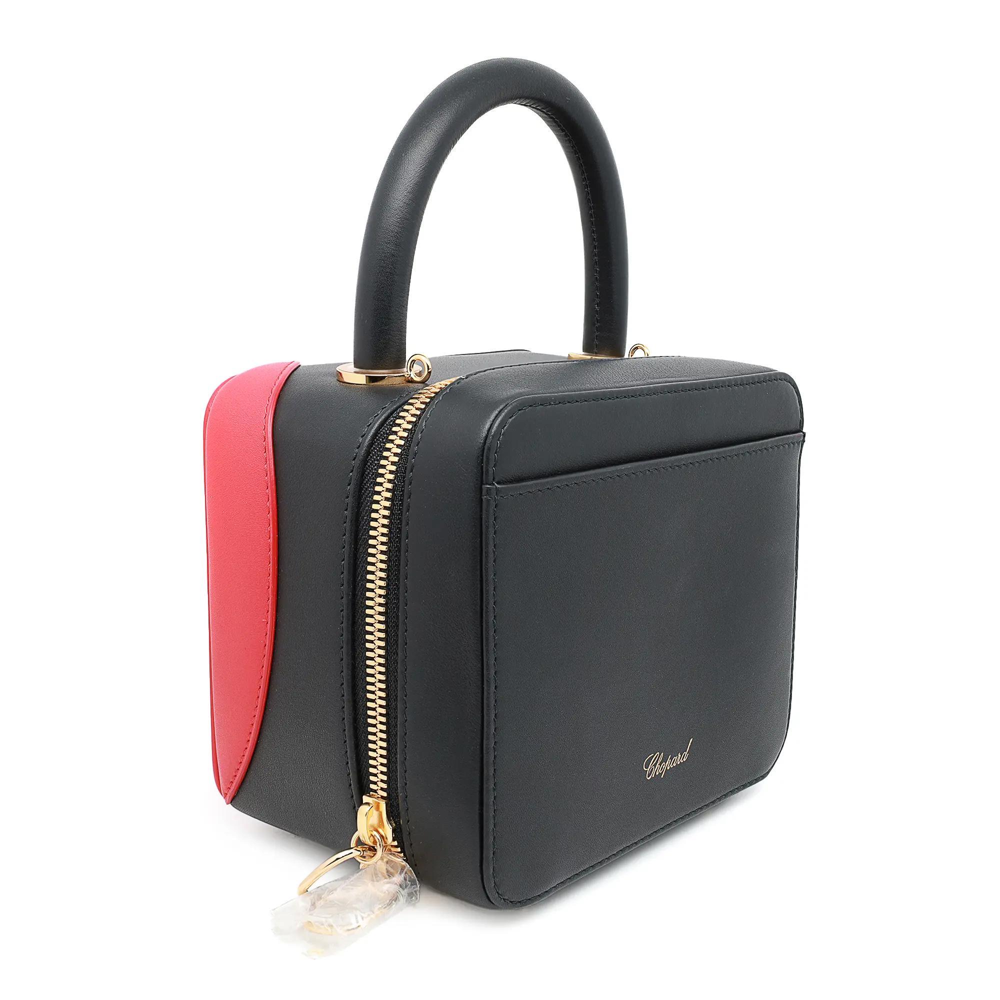 Chopard x Chloë Sevigny leather shoulder bag, model number 9500-0980. This brand-new item comes in blue and red calfskin leather with a detachable metal chain crossbody strap. This exquisite Italian handbag is the result of a collaboration between