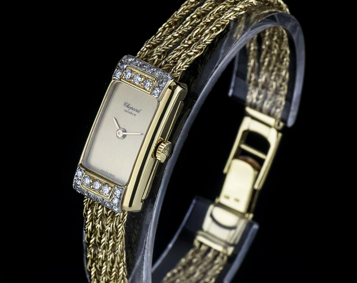 A 1980s 18k Yellow Gold Vintage Cocktail Ladies Wristwatch, champagne dial, an 18k yellow gold fixed bezel set with 26 round brilliant cut diamonds, an 18k yellow gold rope chain bracelet with an 18k yellow gold jewellery style clasp set with a