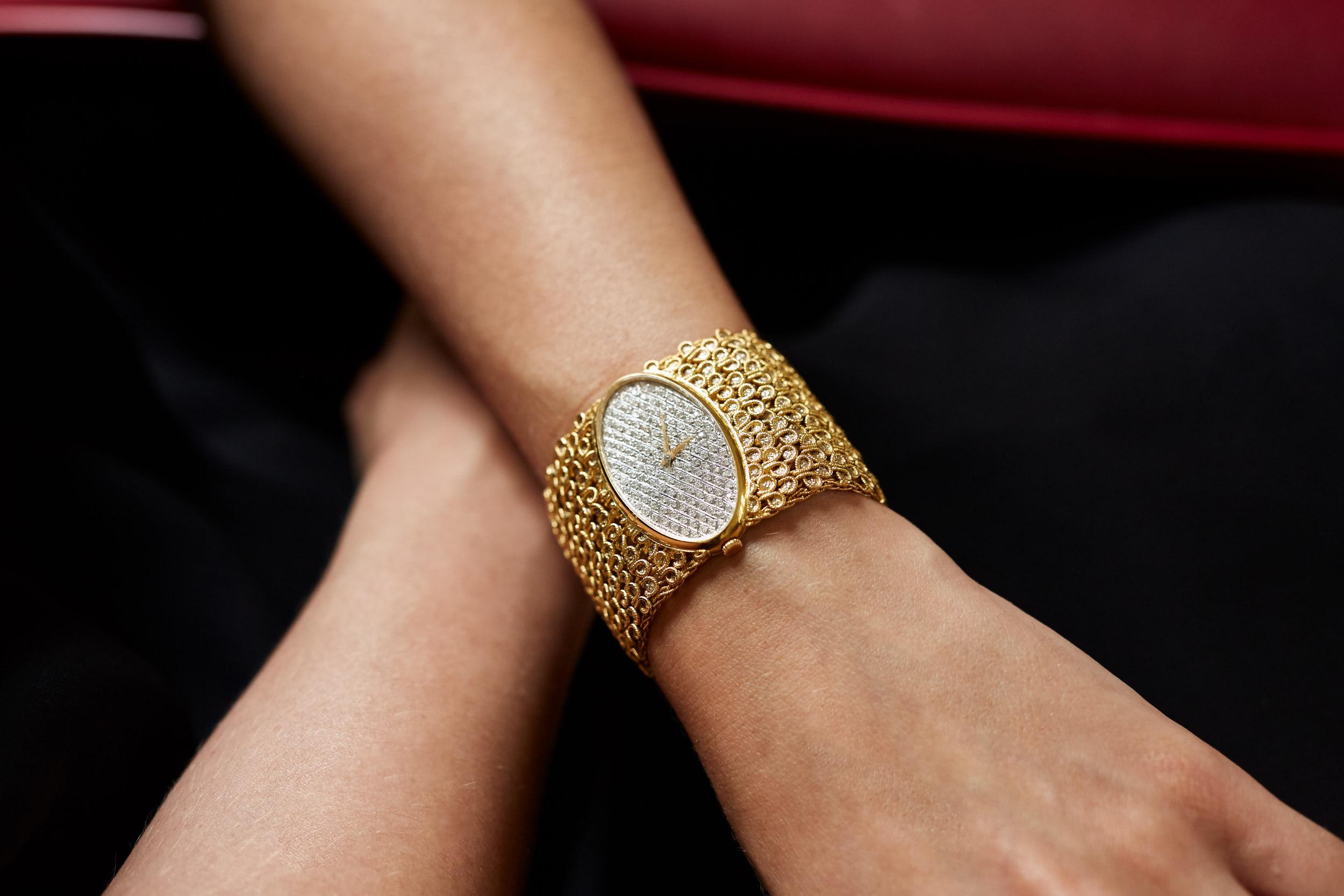 An elegant and eye-catching 18 karat yellow gold and pavé-set diamond wide bracelet watch, by Chopard, 1970s. Vintage jewelry. 
Pavé-set diamonds weighing approximately 1.45 carats total.
The watch has Swiss gold marks and is stamped LUC on the