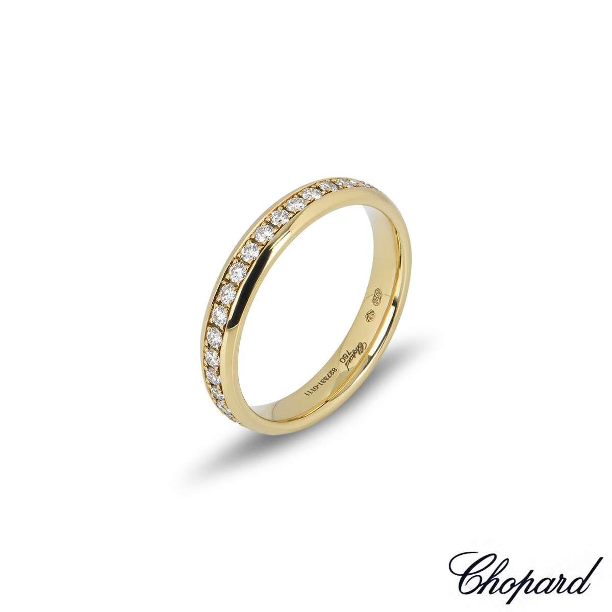 An 18k yellow gold diamond eternity band by Chopard. The ring features 36 round brilliant cut claw set diamonds totalling 0.54ct, F-G colour and IF-VVS in clarity. The 3.5mm wide ring is a size UK N½ - EU 54 - US 6.75 and has a gross weight of 3.7