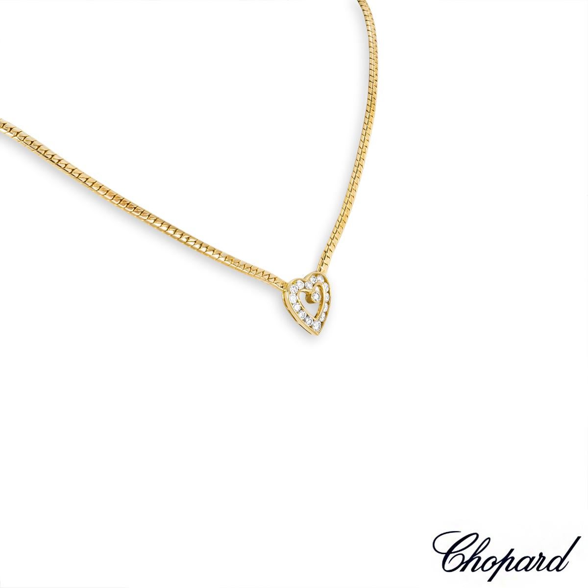 A beautiful 18k yellow gold diamond necklace by Chopard. The necklace features an open heart motif set to the centre, channel set with 14 round brilliant cut diamonds and bezel set with a single diamond, with an approximate total weight of 0.94ct,