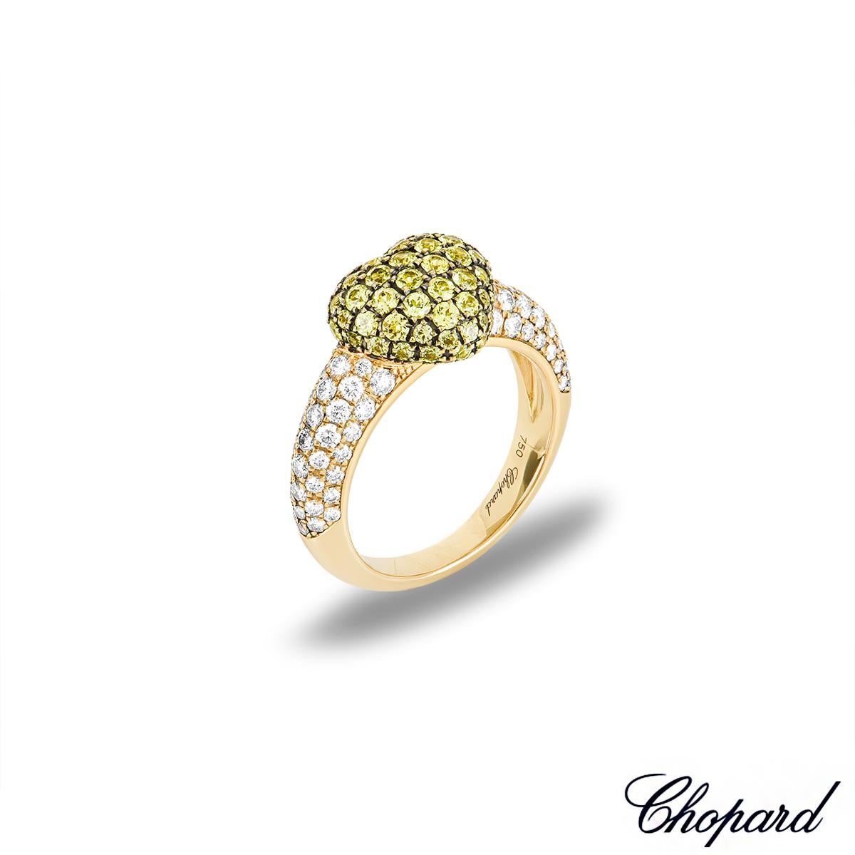 A charming 18k yellow gold diamond and yellow sapphire ring by Chopard. The ring features a heart shaped motif pave set with 71 round cut yellow sapphires. Accentuating the central heart motif are 74 round brilliant cut diamonds pave set to the