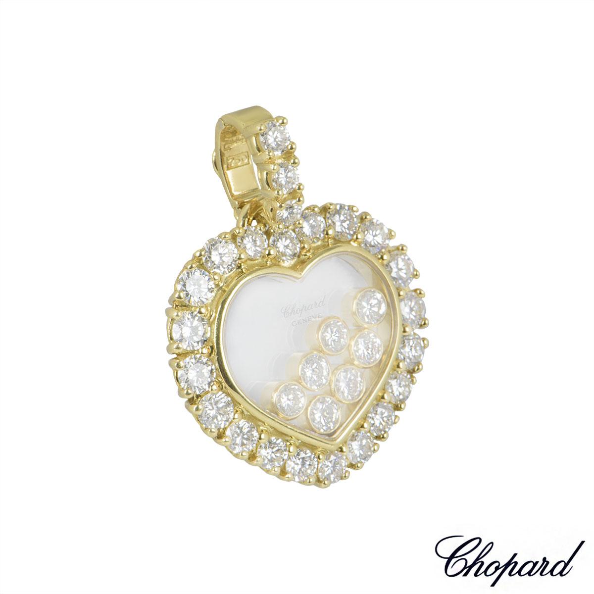 An 18k yellow gold pendant by Chopard from the Happy Diamonds collection. The pendant has 23 claw set round brilliant cut diamonds on the clasp and surrounding the outer edge totalling approximately 1.47ct. In the centre are 7 round brilliant cut