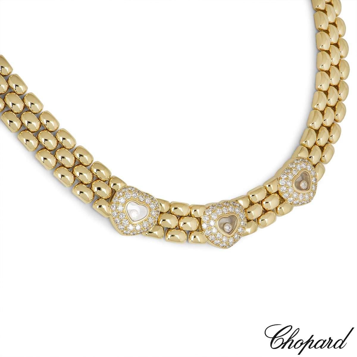 A beautiful 18k yellow gold heart necklace by Chopard from the Happy Diamonds collection. The necklace features 3 heart motifs pave set with round brilliant cut diamonds, with the iconic Chopard signed glass in the centre encasing a single floating