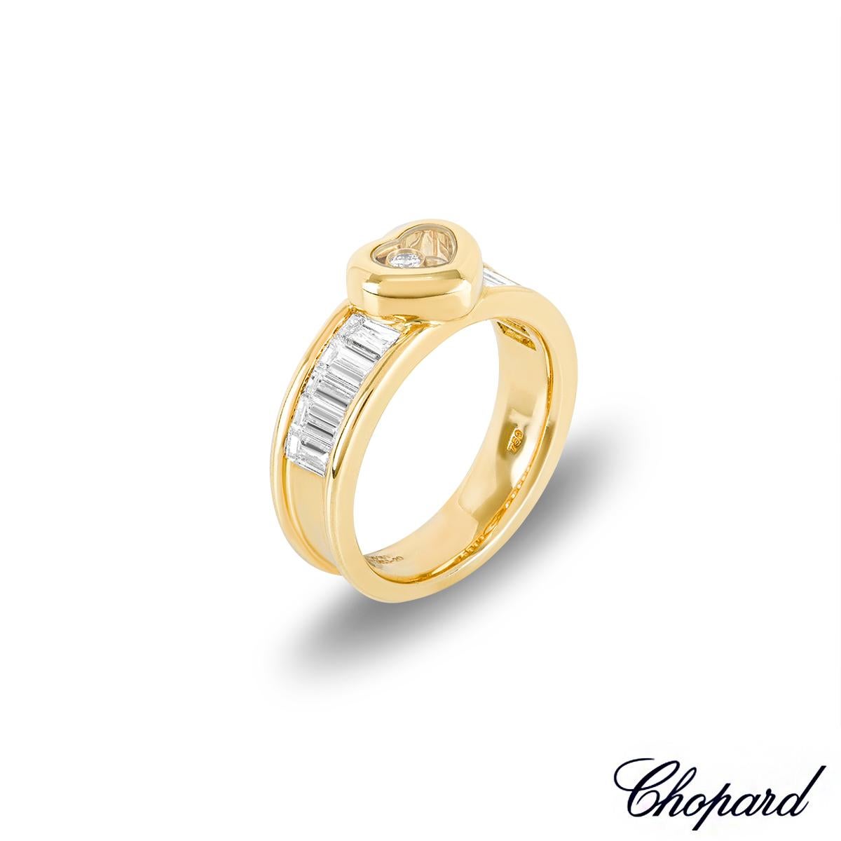 A lovely yellow gold ring from the Chopard Happy Diamonds collection. The ring is set to the centre with a heart motif, made up of the iconic Chopard signed glass, encasing a 0.05ct single bezel set floating diamond. Complementing the motif are 10
