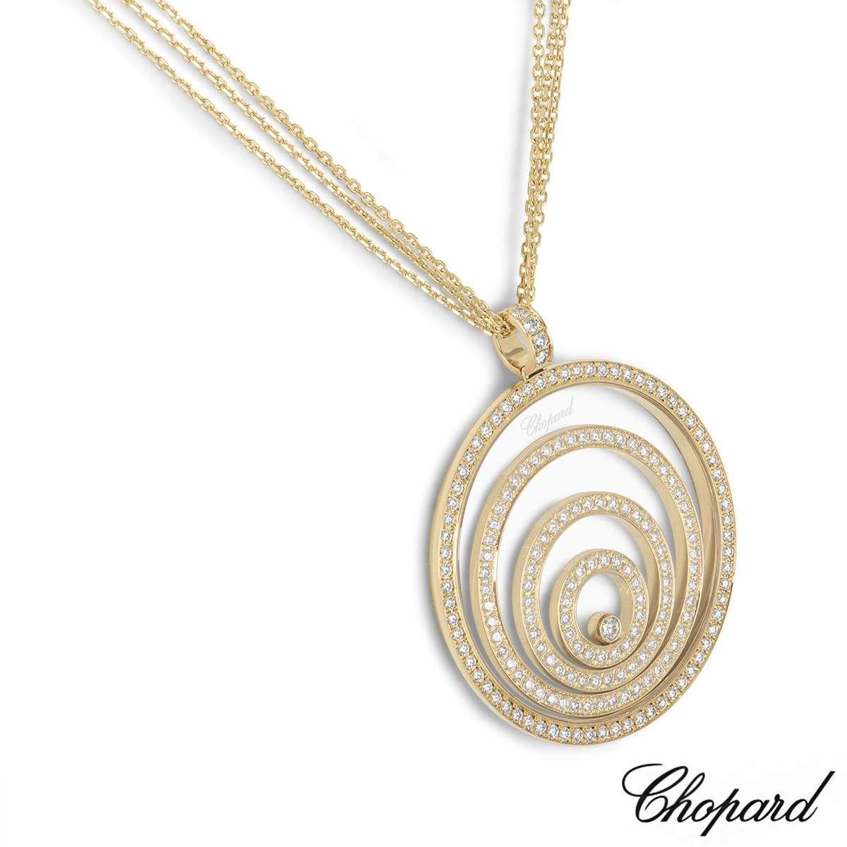 An 18k yellow gold pendant from the Happy Spirit collection by Chopard. The circular pendant consists of a diamond set bale and outer case with 3 diamond set circular floating motifs, complimented by a single floating diamond in the centre. The