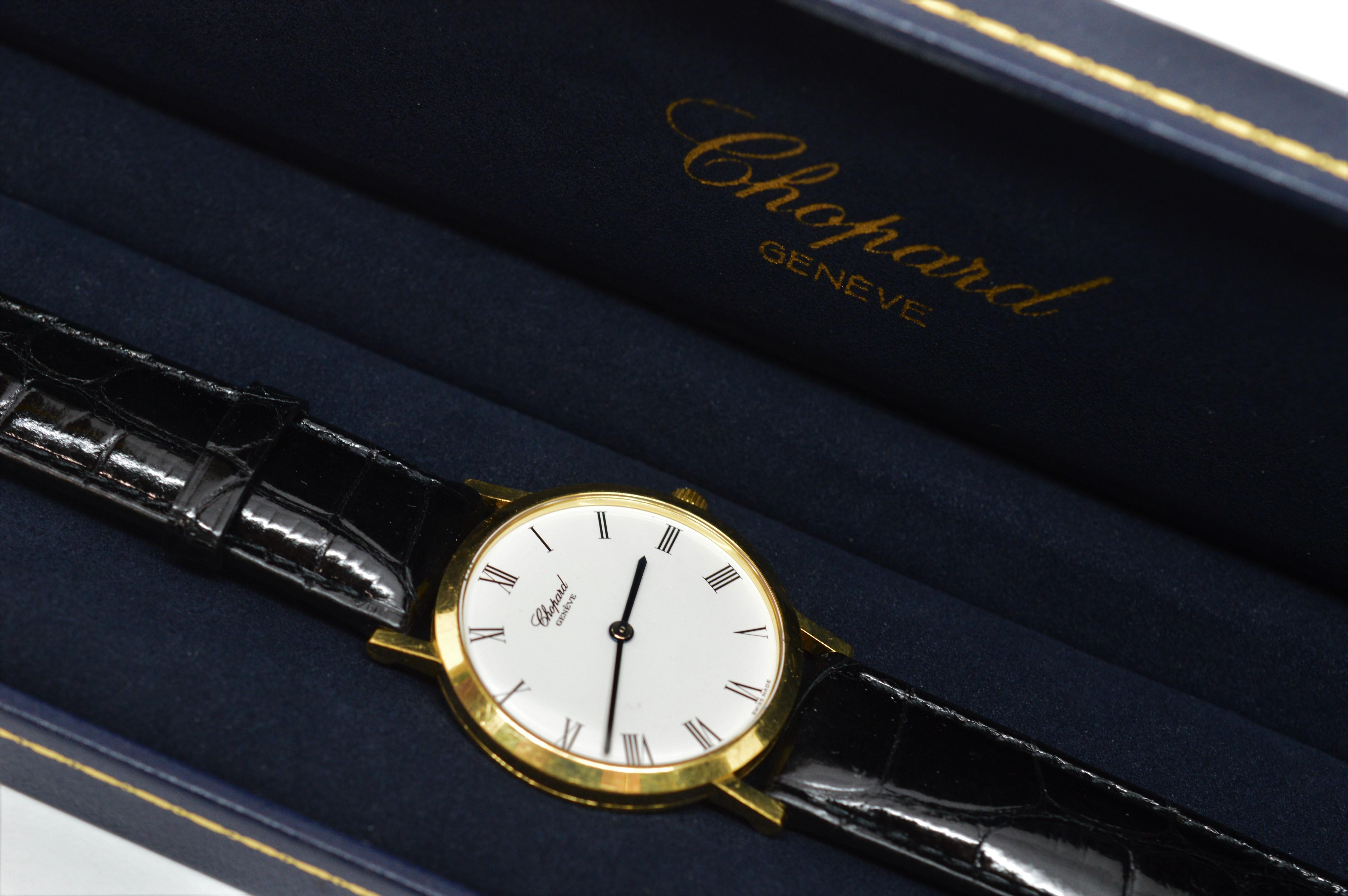 Swiss craftsmanship is evident in this sleek and sophisticated eighteen karat 18K yellow gold Chopard Men's Wristwatch. With a mineral crystal, pleasing white face and easy to read Roman numerals, the watch has a 20 jeweled mechanical movement. The