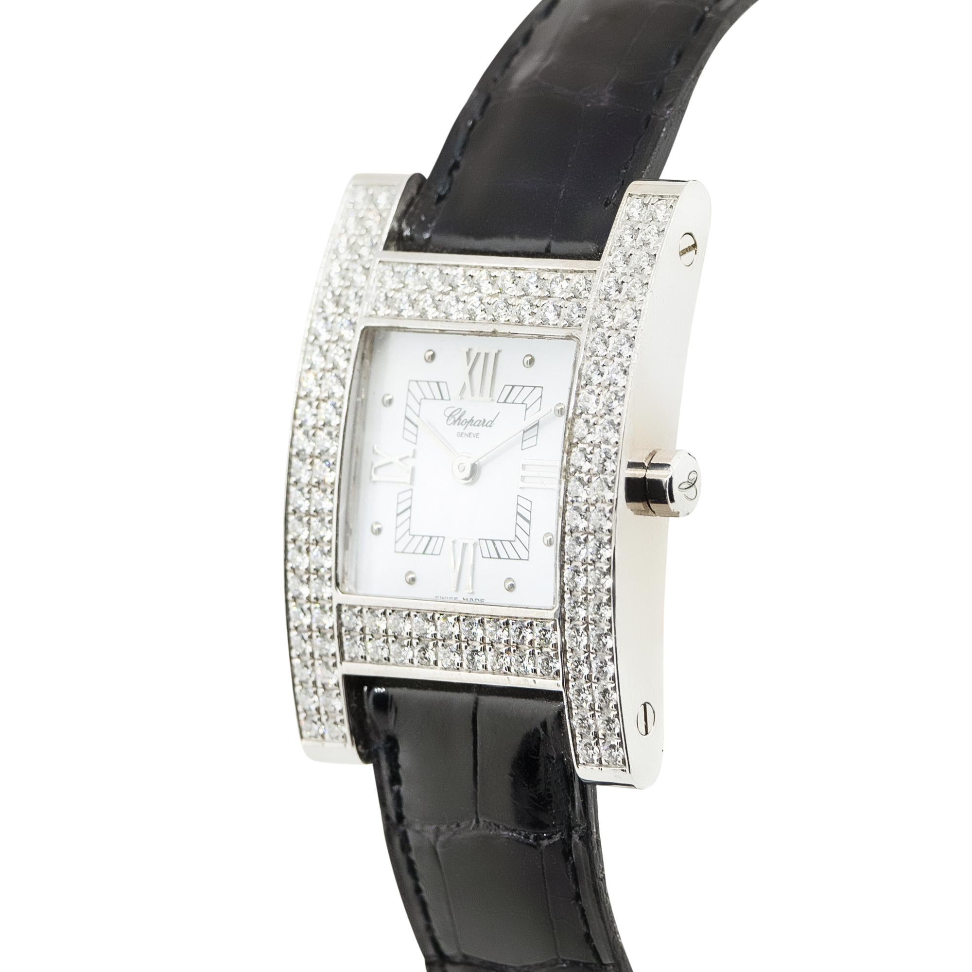 Brand: Chopard
Model: Your Hour
Case Material: 18k White Gold
Case Diameter: 24.5mm
Bezel: 18k White Gold with 2 Rows of Diamonds Bezel
Dial: White with Roman Numerals Dial
Bracelet: Black Leather
Size: 6