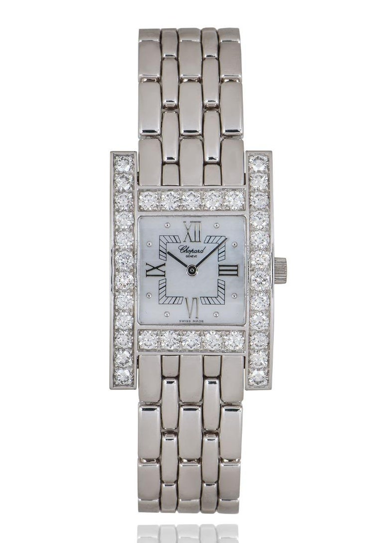 A 24 mm white gold Your Hour by Chopard, featuring a white mother of pearl dial and H-shaped bezel and case set with 34 round brilliant cut diamonds. The white gold bracelet comes with a jewellery style clasp, also in white gold. Fitted with