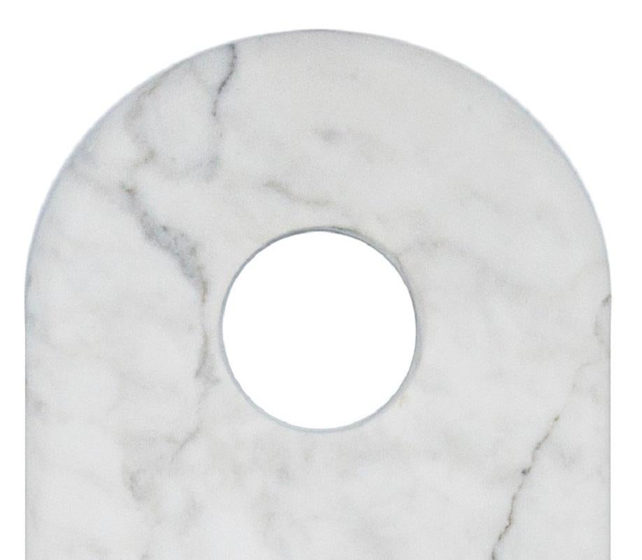 Chopping board with hole for hanging in white Carrara marble.

Each piece is in a way unique (every marble block is different in veins and shades) and handmade by Italian artisans specialized over generations in processing marble. Slight variations