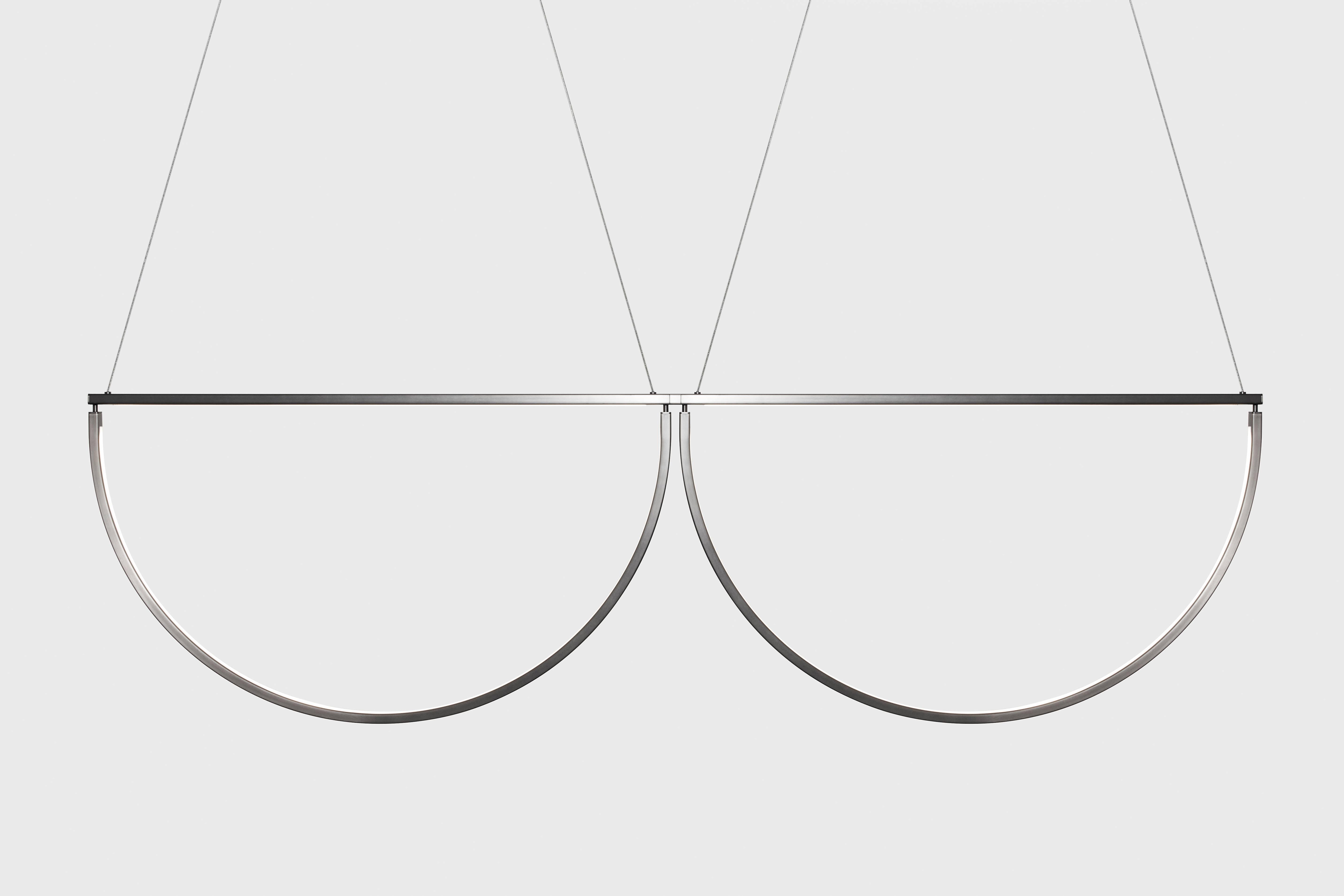 The Chord Convoy, an iterative form of the Chord Pendant, is a playful and elegant linear light. The fixture can exist as a pair of pendants, or be extended to form an endless line in varying sizes or finishes. As the curved steel pieces are grouped