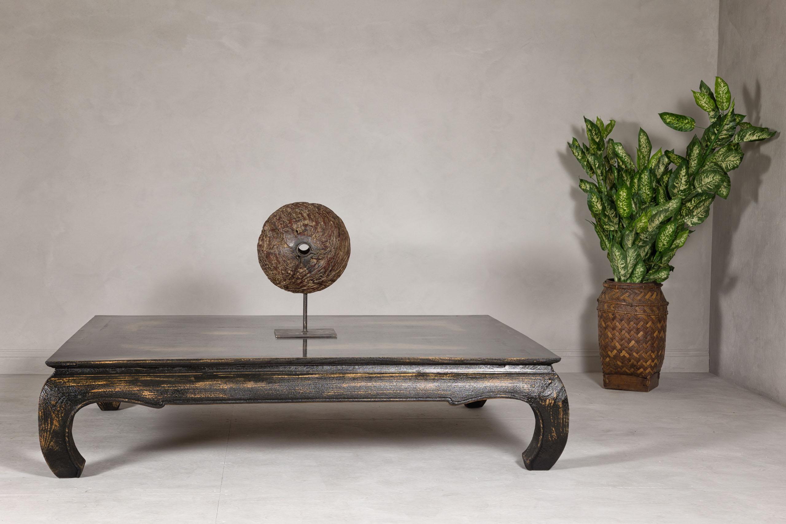 A Chow leg low Kang coffee table from the mid 20th century with custom black distressed finish. Elevate your living space with the timeless sophistication of this mid-20th century Chow leg Kang coffee table, masterfully restored to accentuate its