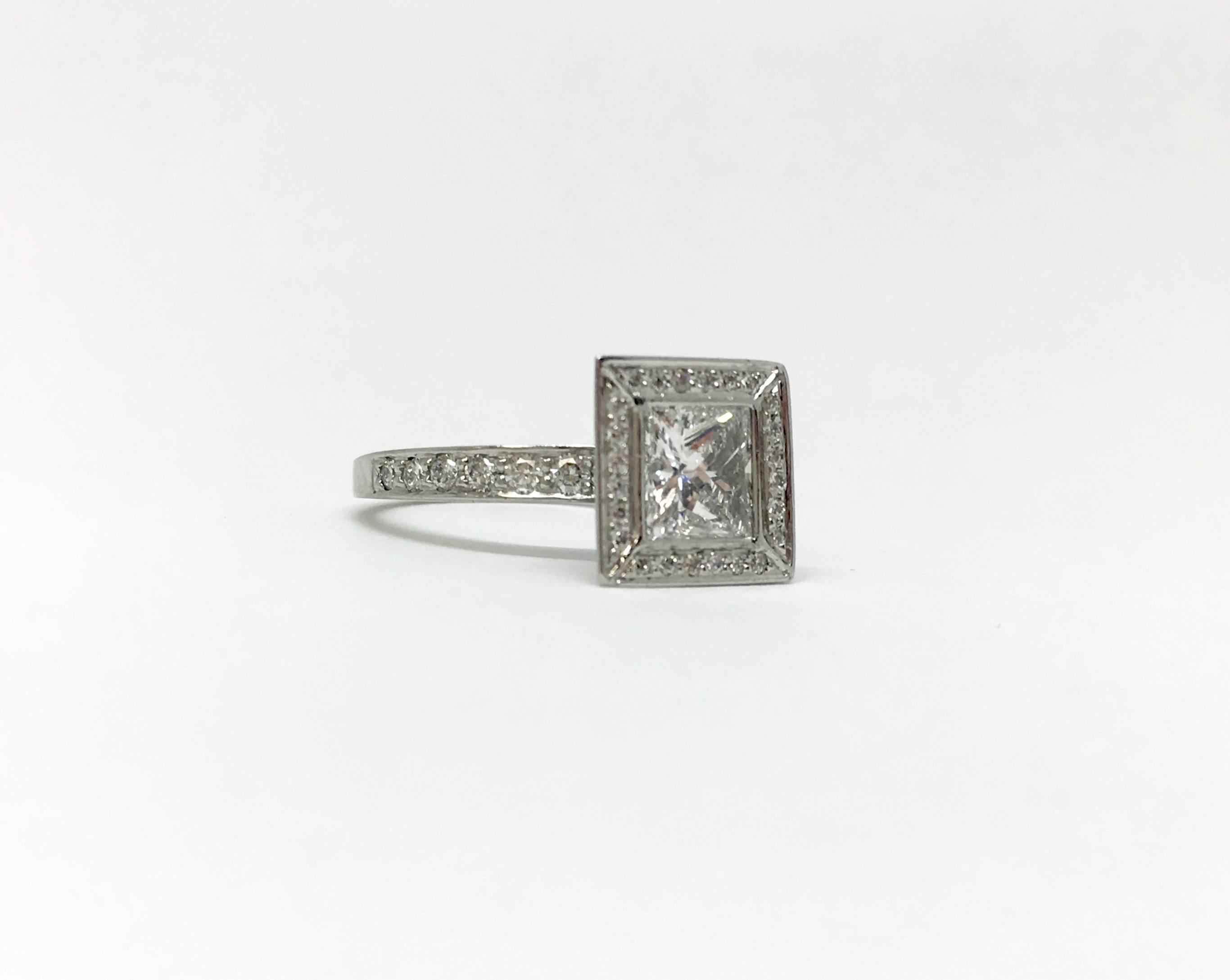 Chris Correia designed princess diamond ring in platinum. The center princess cut diamond is 1.00 carat SI1 clarity, GH colour. It is detailed beautifully with 90 surrounding round brilliant cut diamonds totaling .43 carats. The finger size is