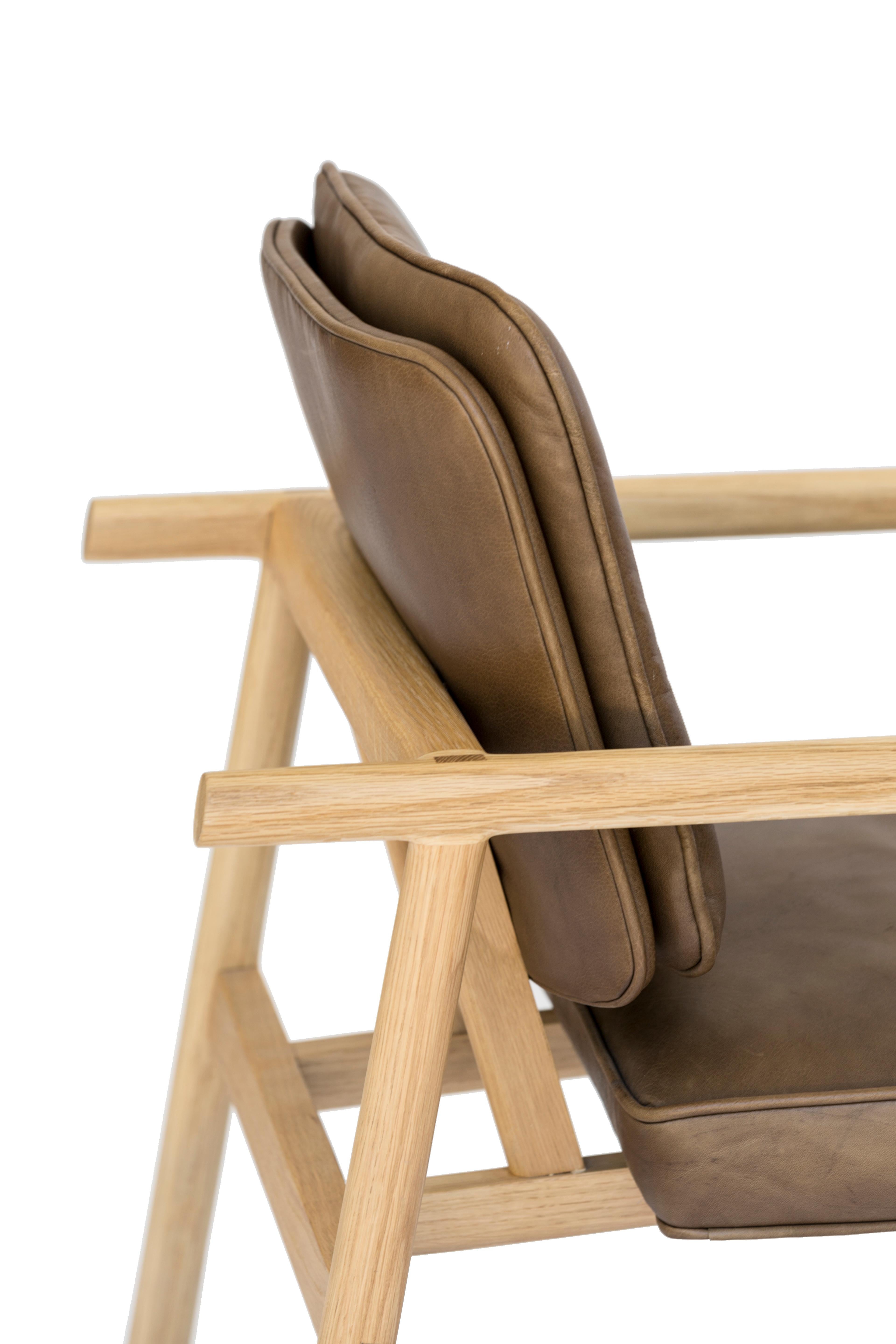 Solid wood construction with hand-cut joinery and custom upholstered seat and seat back. This chair shown in natural oak and olive leather.

In stock leather choice: black, olive, camel or vegtan leather.
Wood choice: ebonized oak, walnut, natural