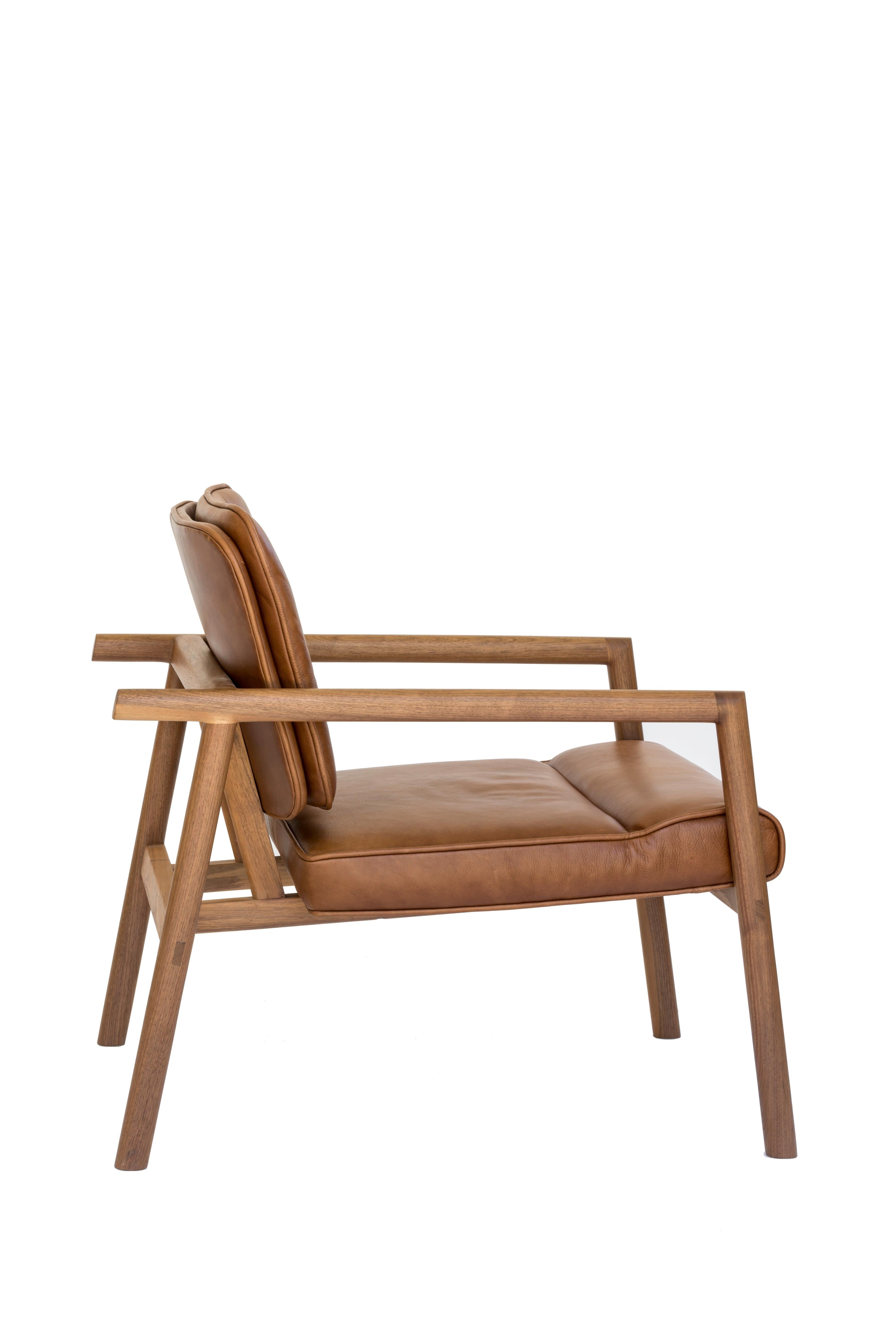 Solid wood construction with hand-cut joinery and custom upholstered seat and seat back. This chair shown in walnut and camel leather.

In stock leather choice: black, olive, camel or vegtan leather.
Wood choice: ebonized oak, walnut, natural oak or