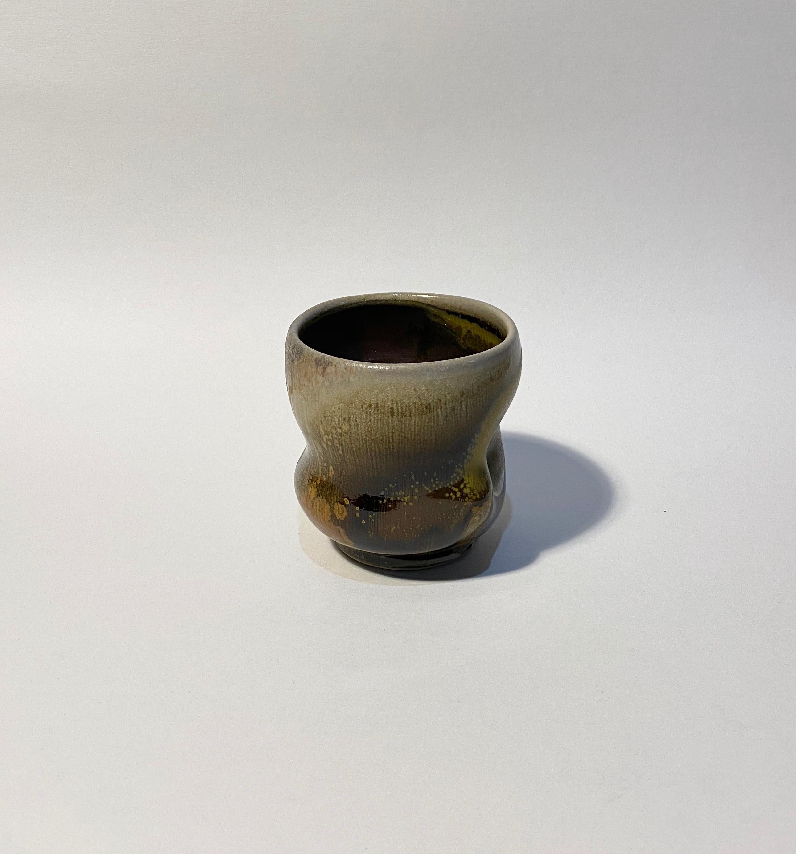 Chris Gustin (born 1952)
Whiskey cup, 2019
Stoneware
Measures: 3 5/8 x 4 x 3 1/2 inches
Anagama wood fired
Signed on the underside with the artist's device

Chris Gustin is a studio artist and Emeritus Professor at the University of