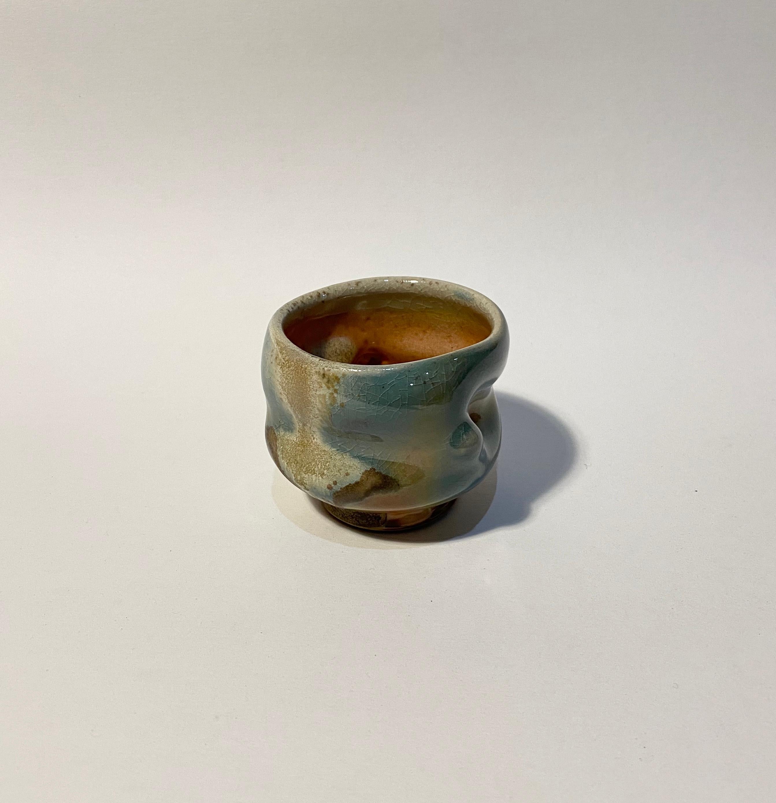 Chris Gustin, (born 1952)
Whiskey Cup, 2019
Porcelain
Measures: 2 7/8 x 3 3/8 x 3 3/8 inches
Anagama wood fired
Signed on the underside with the artist's device

Chris Gustin is a studio artist and Emeritus Professor at the University of