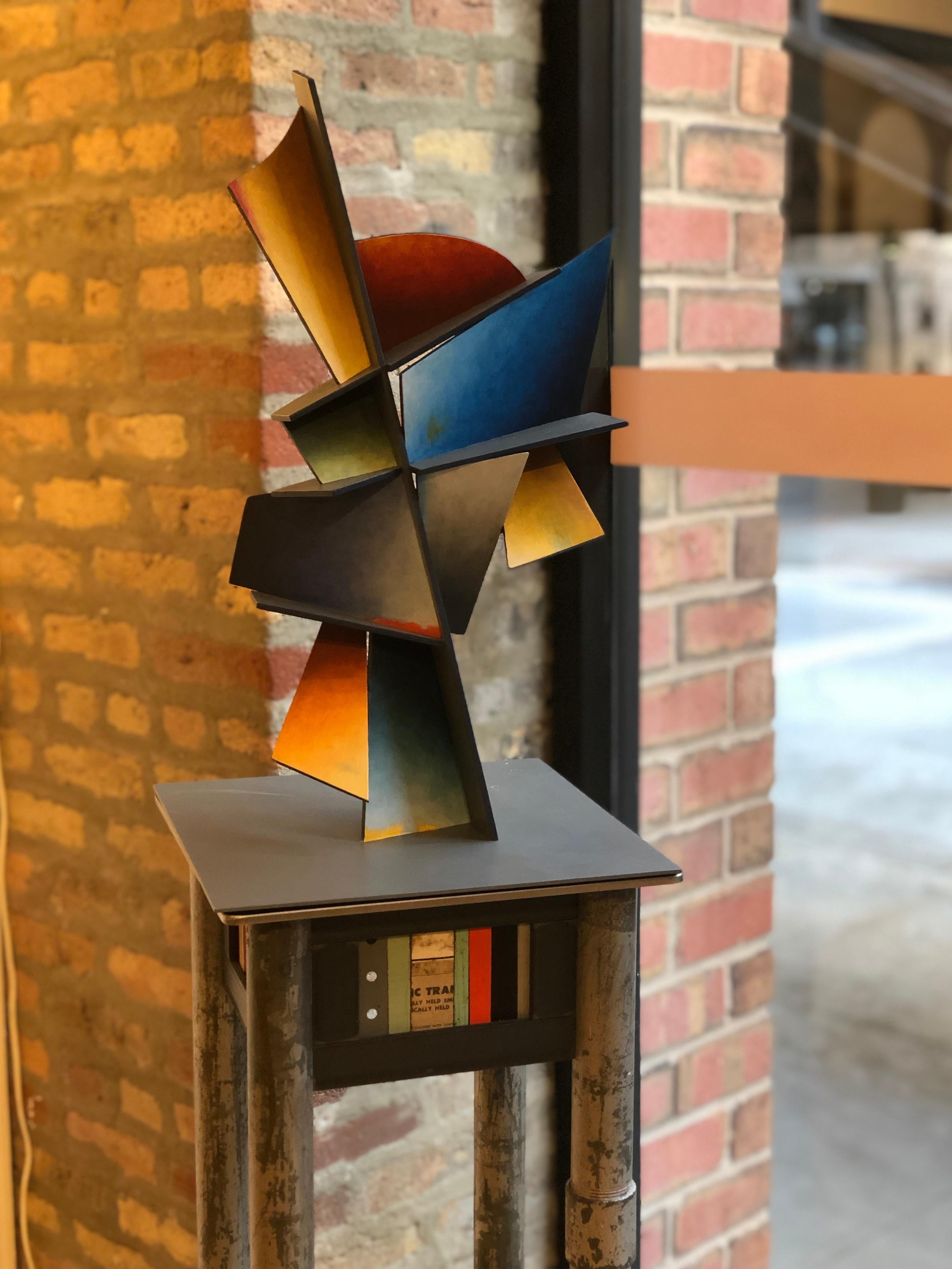 This dynamic table sized sculpture is created from sheets of steel welded together in an abstract geometric pattern bright blue, orange, purple and yellow dominate and are balanced by softer hues.

Chris Hill
HIdden Hour
steel
20.50h x 12w x 12d
