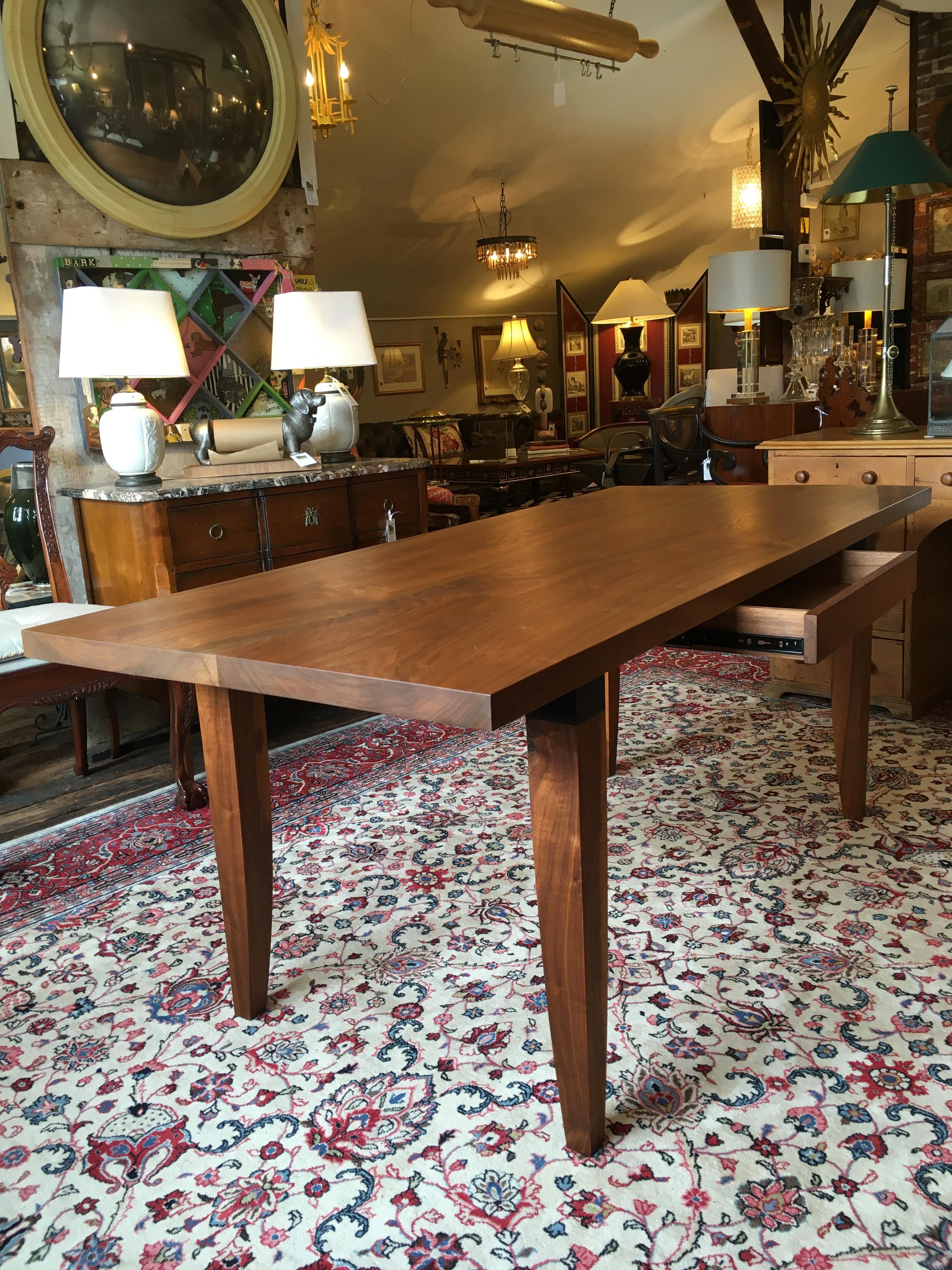 Walnut with blackened cuffs, a custom sleek organic modern dining table with single drawer by Chris Lehrecke. Could also be used as a large writing table. Lehrecke has been designing and building furniture since 1982. While his early pieces were