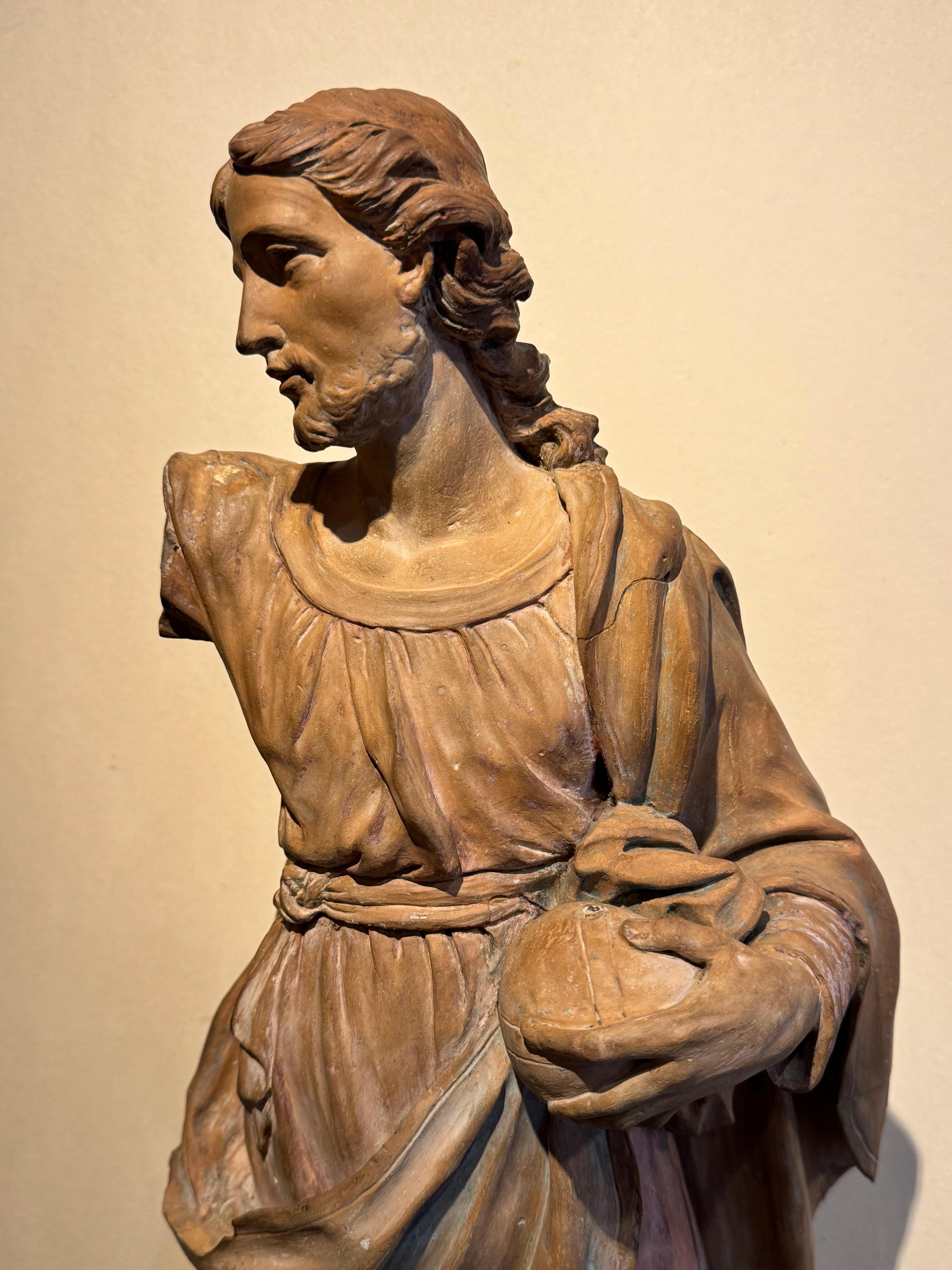 Large original terracotta depicting Christ blessing, carrying the globe in his left hand. Traces of polychromy, missing the right arm, and a fold in the drapery, but very beautiful overall impression with nervous sculpture and great realism.