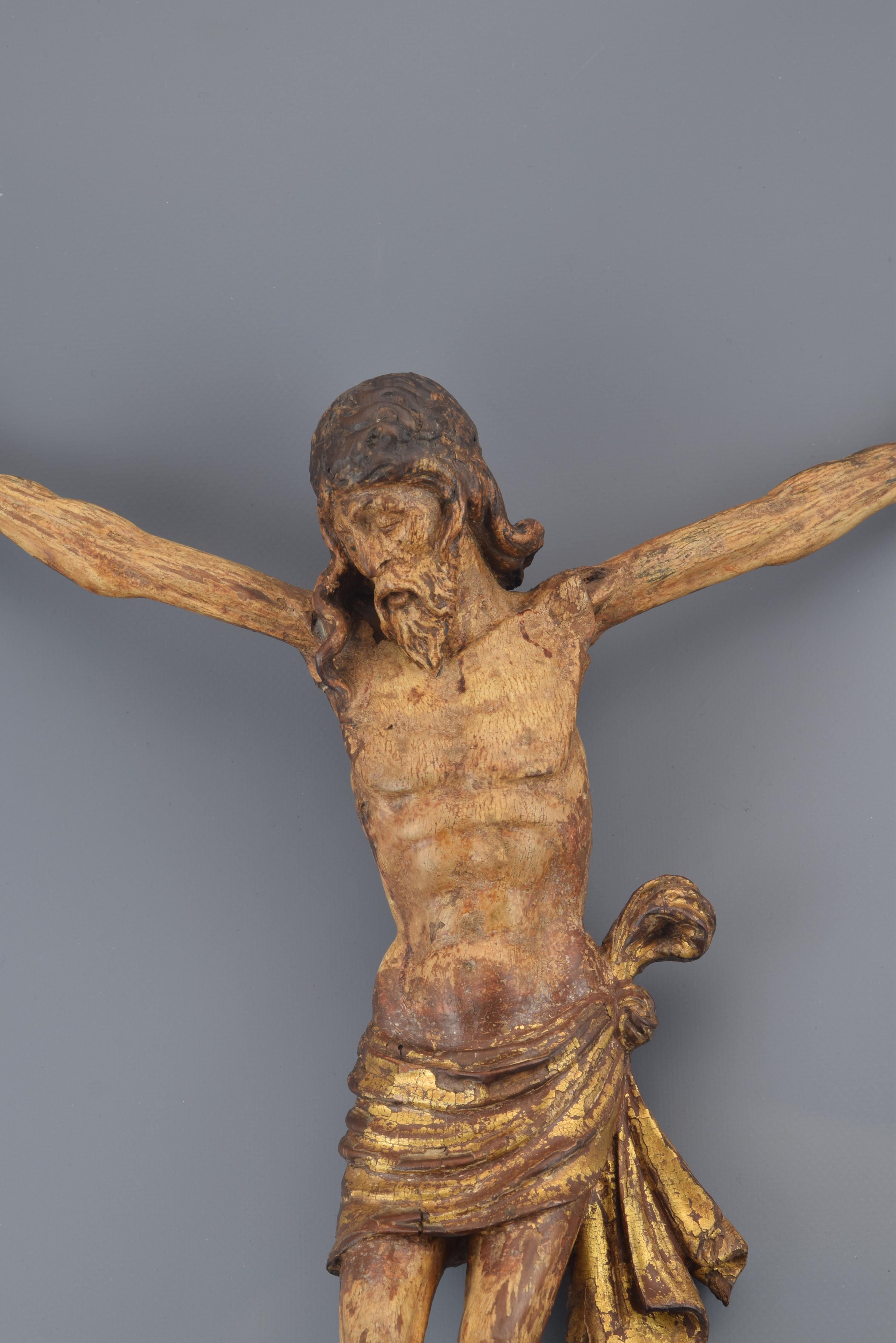 Sculpture in carved wood, gilded and polychrome representing Christ Crucified, with three nails (following a usual iconography since the Gothic) and short purity cloth knotted to one hip, face and head slightly tilted and turned and eyes closed and
