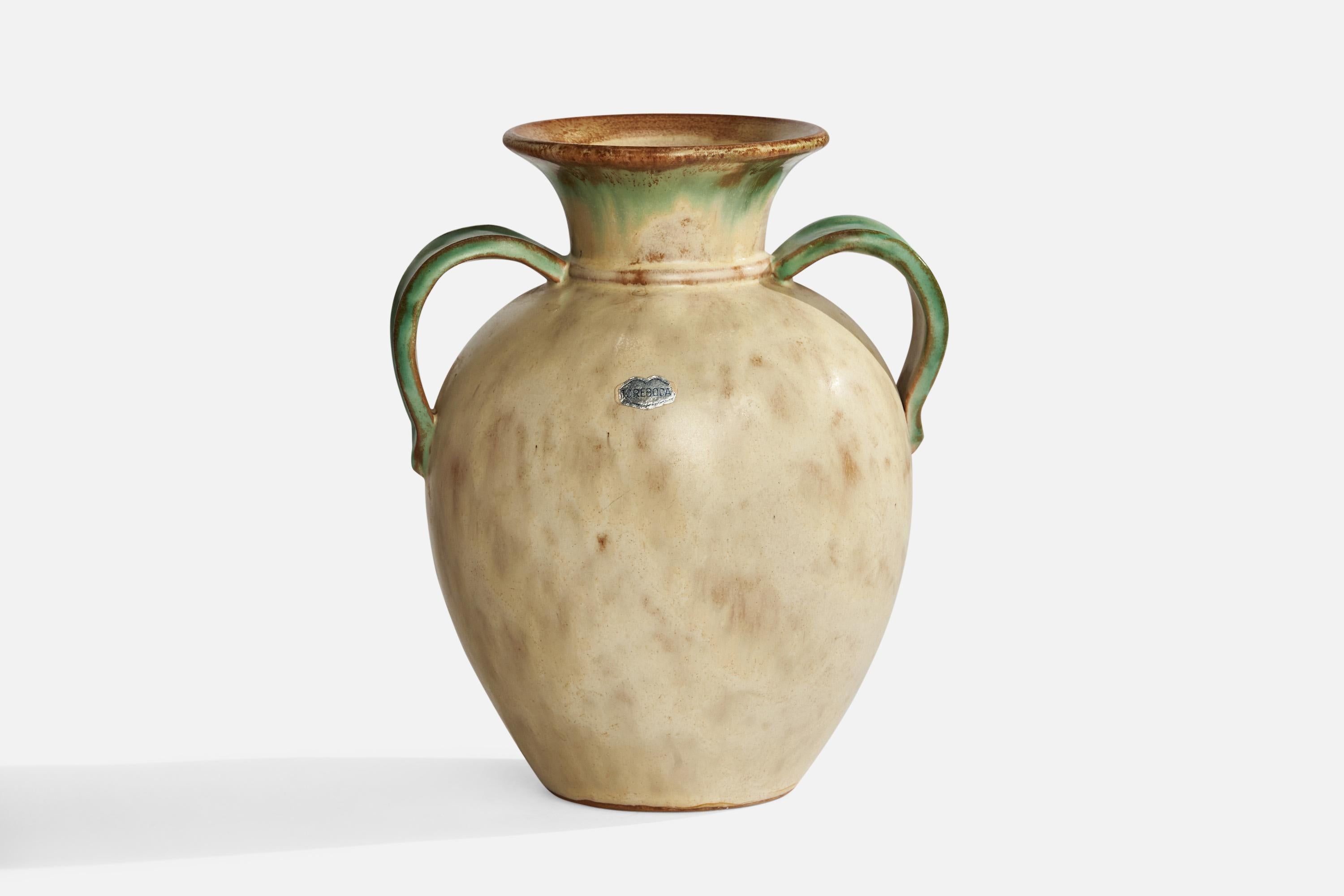 An off-white and green-glazed ceramic vase designed by Christer Heijl and produced by Töreboda Keramik, Sweden, 1930s.