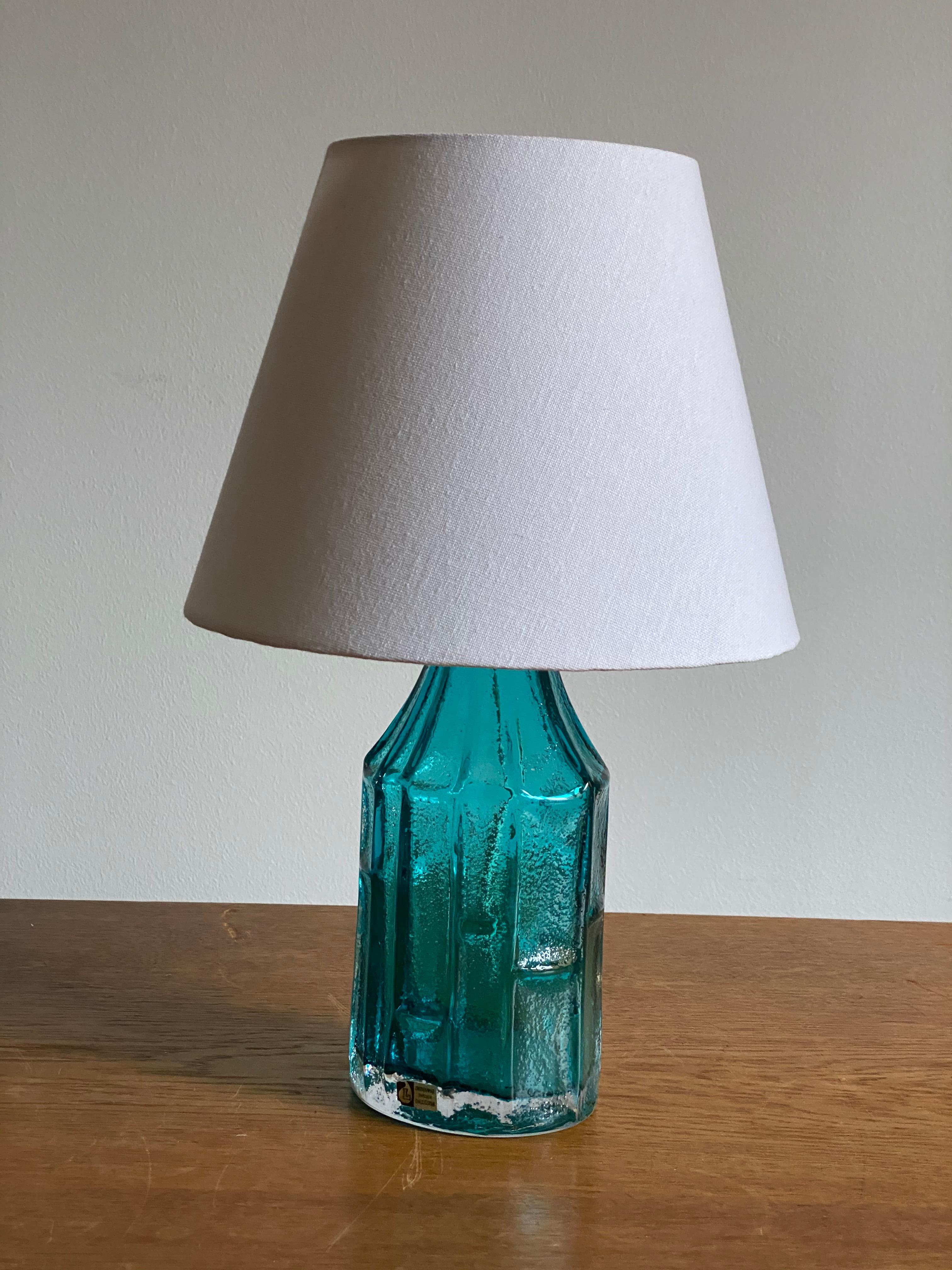 A table lamp in blue-colored glass. Designed by Christer Sjögren, produced by Lindshammar, Sweden. With manufacturers label.

Other designers of the period include Orrefors, Paavo Tynell, Lisa Johansson-Pape and Josef Frank.