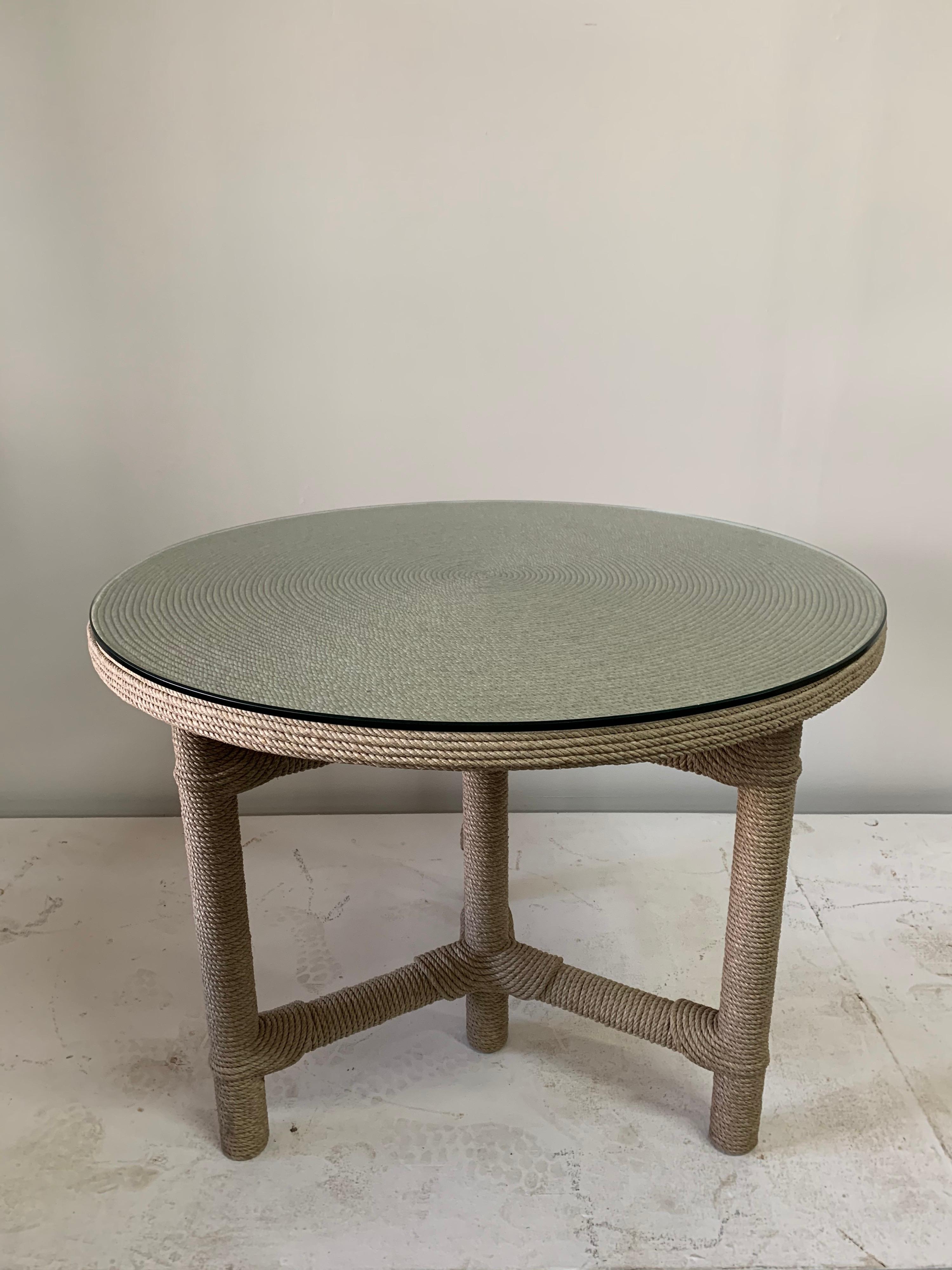 This rope cord covered table by famed Master artist Christian Astuguevieille, named the Arfiba table with original custom glass top protector. Natural colored cord and in fine vintage condition. Tribal notes to this design.

Note: Height of table