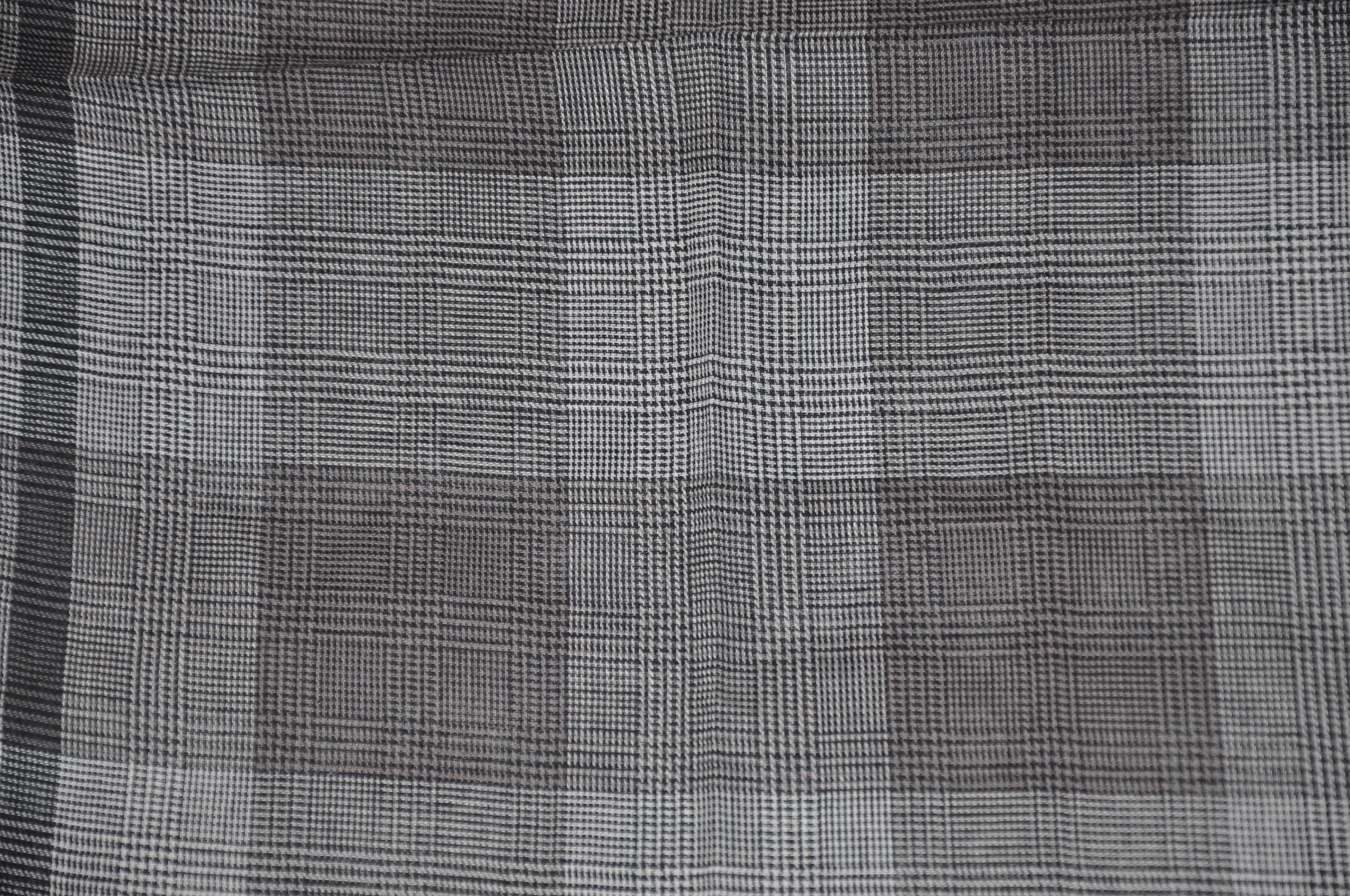      Christian Aujard shades of gray micro checkered cotton handkerchief with stitched edges, measures 18 inches by 18 inches. Made in France.