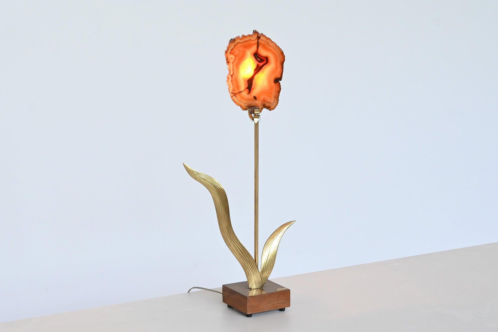 Beautiful and unique flower shaped table model Violette designed and made by artist Christian Caramin, France 1988. It has a solid teak wooden base with hand cut brass leaves and a wonderful agate. This sculptural lamp creates a beautiful impact in