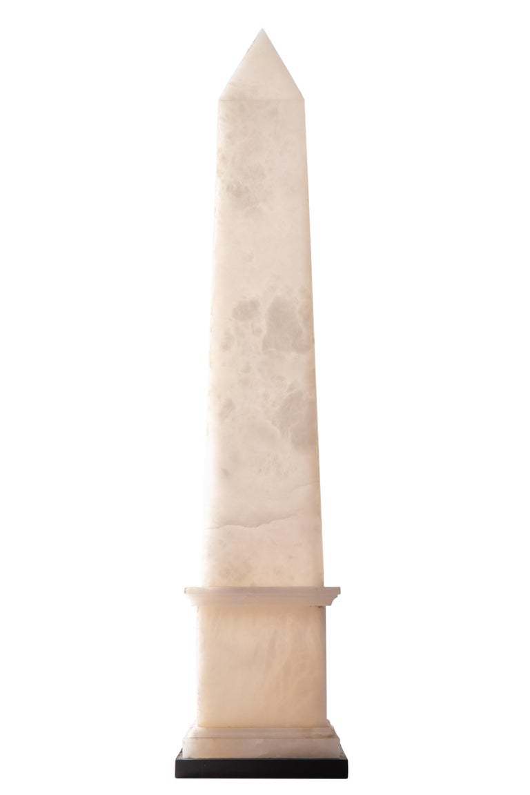 Contempory white alabaster Obelisk lamp designed and produced by Christian Caudron, Meilleur Ouvrier de France 2015*, in his Parisian workshop.

The Obelisk is made of alabaster, a translucent and veined matte stone and sits on a black marble