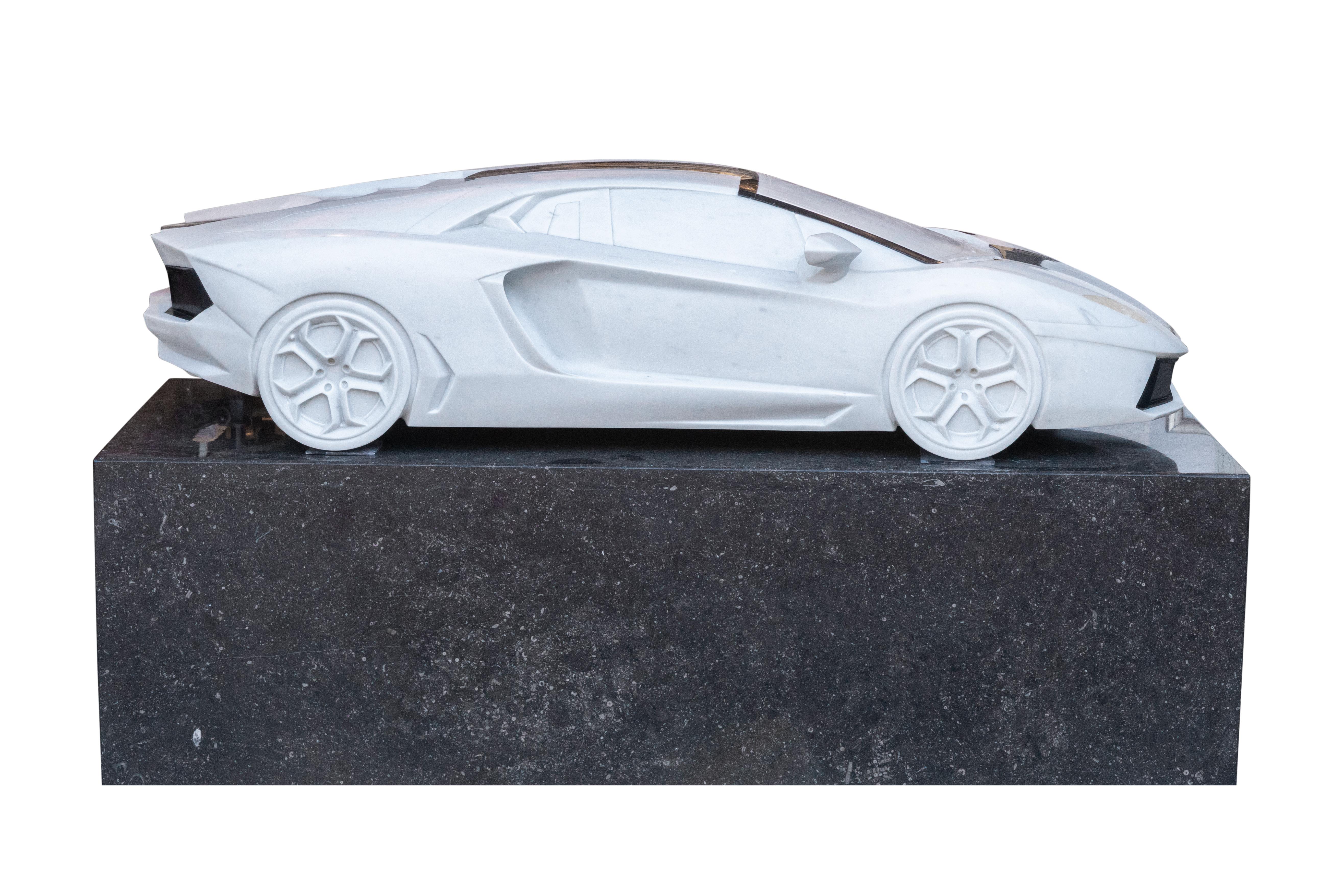 This sculpture in fine white P marble, black Belgian marble and rock crystal is a tribute to the famous car manufacturer Lamborghini, specifically the Aventador LP700-4.

The Lamborghini Aventador is a mid-engine sportscar produced by the Italian