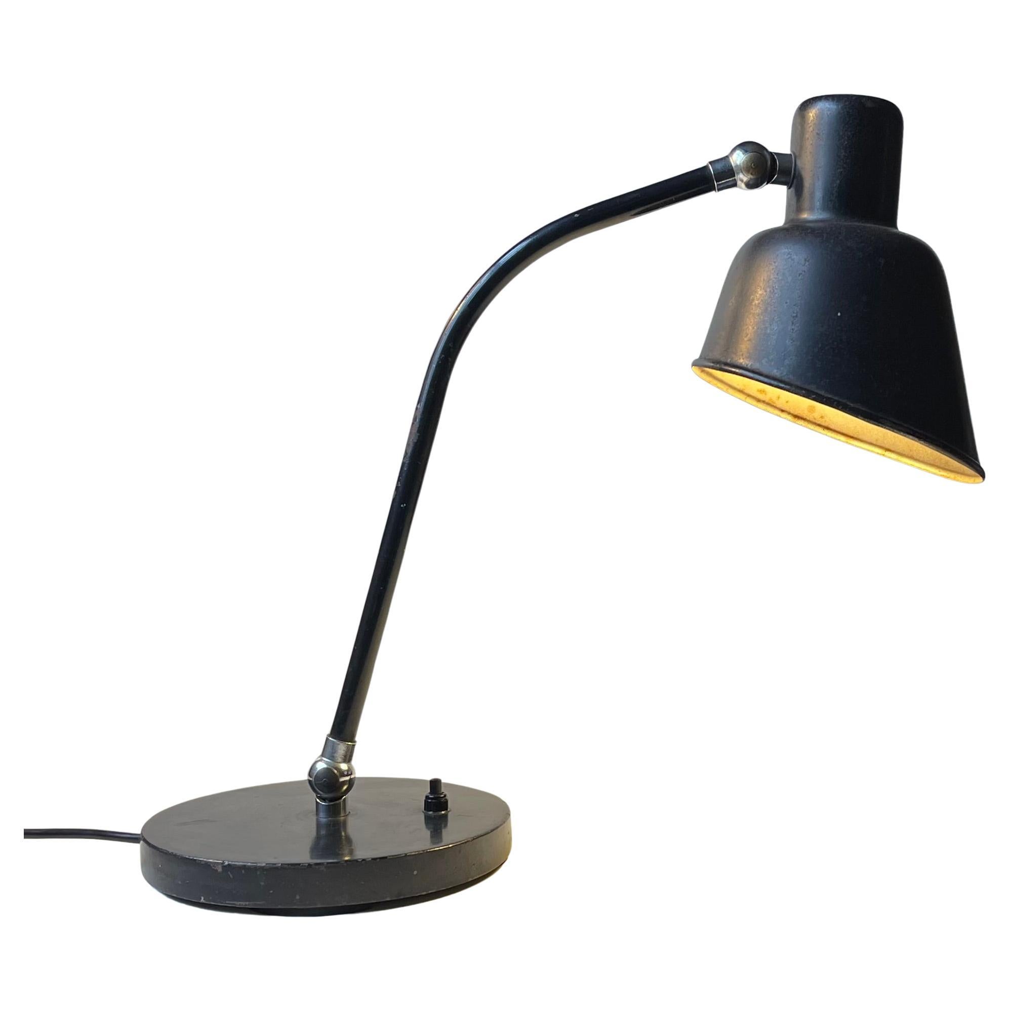 A rare version/configuration of the Matador Desk Lamp. Model 2700A designed by iconic Bauhaus designer and teacher Christian Dell. It is adjustable by the shade and at the base. Its unrestored and retains its original lacquer and 90 years worth of