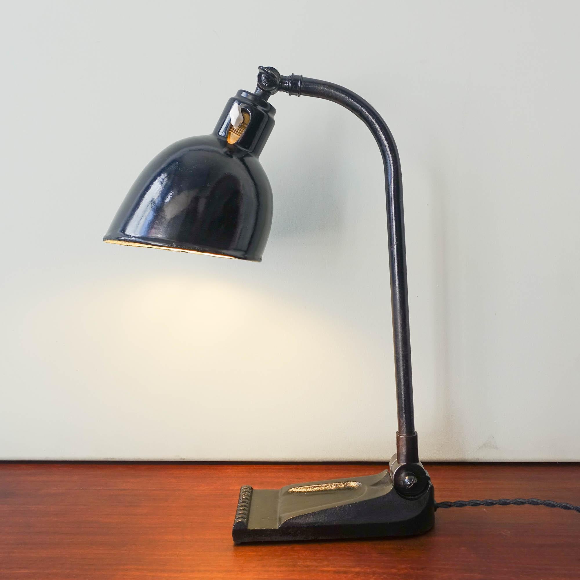 This lamp was designed by Christian Dell for Bünte & Remmler, during the 1930's, in Germany. It can be bent forward or backwards and the lampshade is also adjustable and can be bent upwards or downwards. It is made in metal with a black lacquered