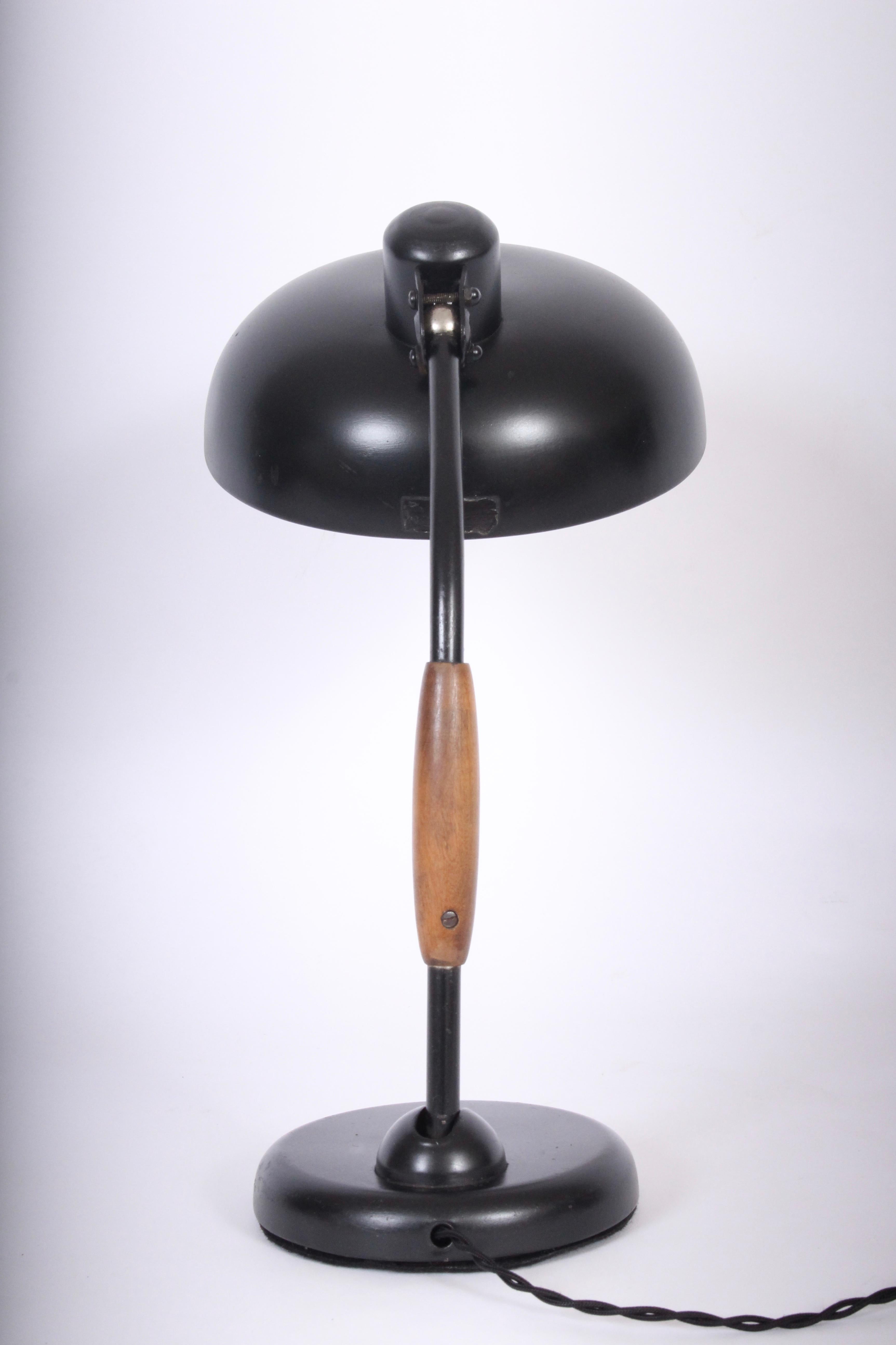 Black wood handled table lamp detail designed by Christian Dell in 1933. Produced by Koranda, Vienna. Featuring a tilt black metal stem, wood handle, adjustable and wide 9D black metal saucer shade on sturdy round 6D metal base. Base switch.