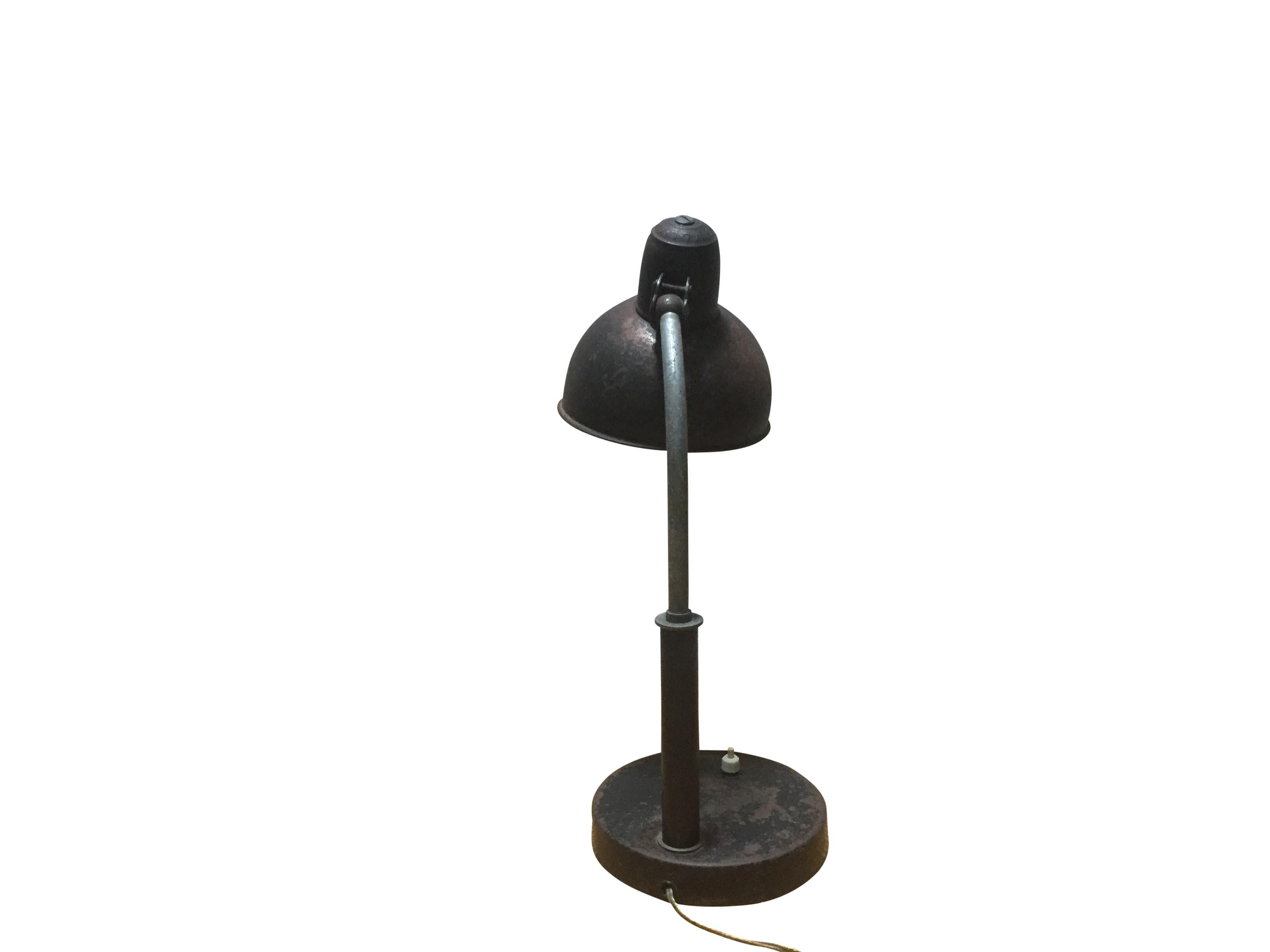 The Kaiser Idell lamp is characterized by Christian Dell's ability to create an elegant design with the basic geometric features of modernism. Adjustable neck and shade hold in any position.
The lamp has a beautiful patina and a nice industrial