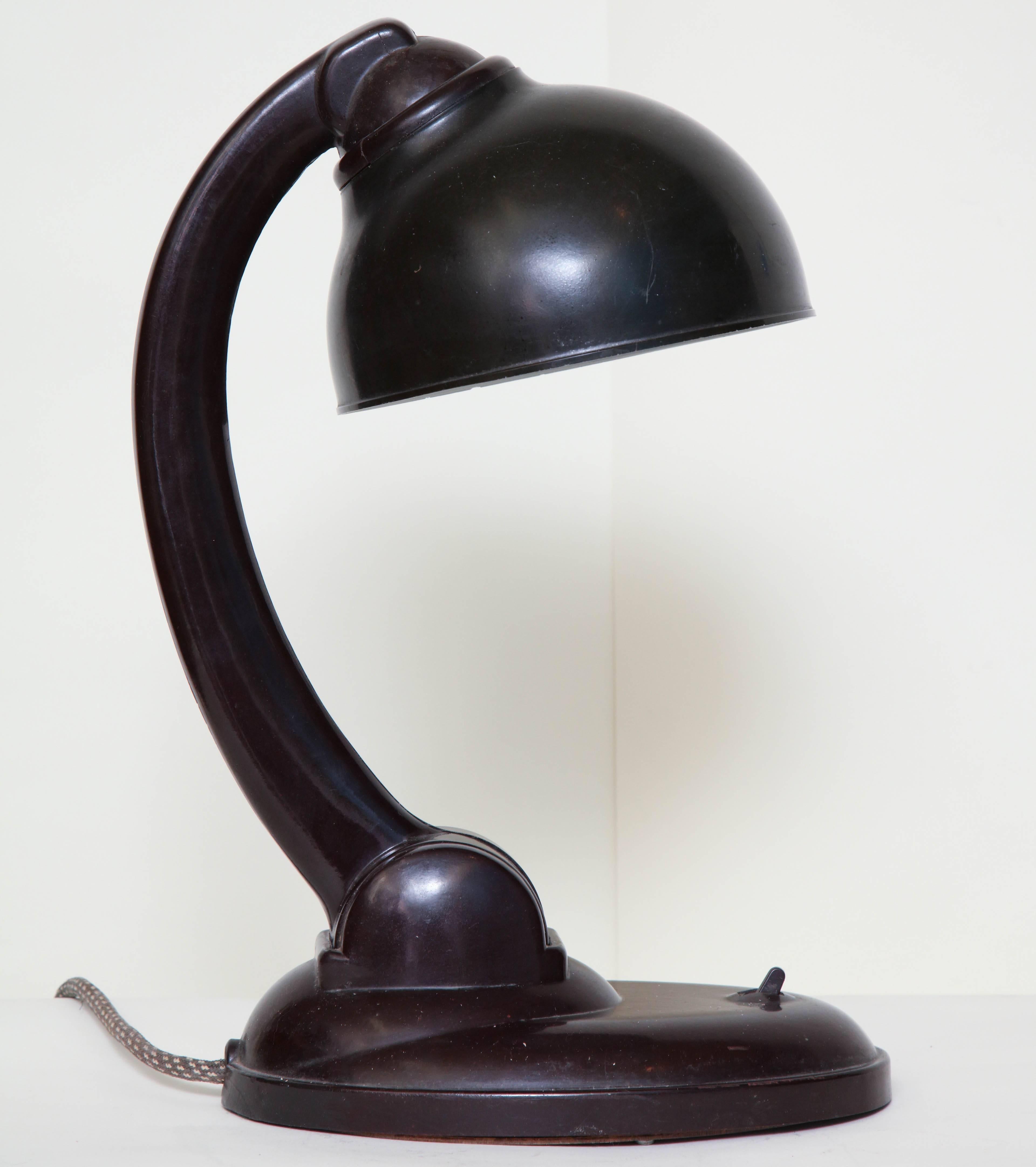 A Christian Dell bakelite table lamp Bauhaus, Germany, circa 1930s
Shade and arm adjusts.