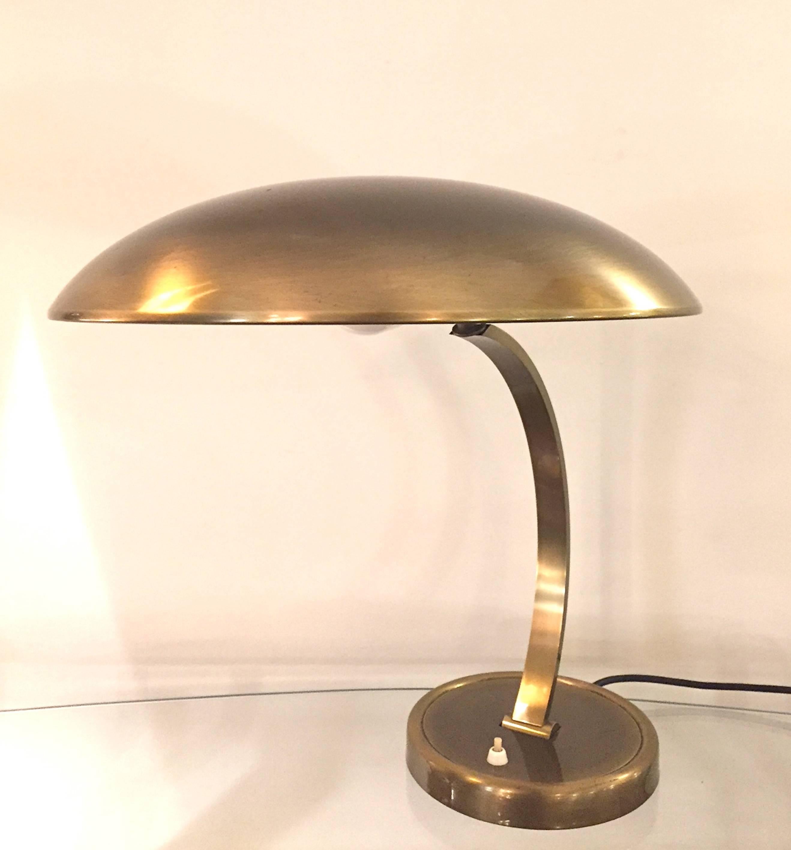 A table lamp designed by Cristian Dell, model 6751 and manufactured by Kaiser Idell. Brass. Both arms and shade are adjustable. Excellent condition.