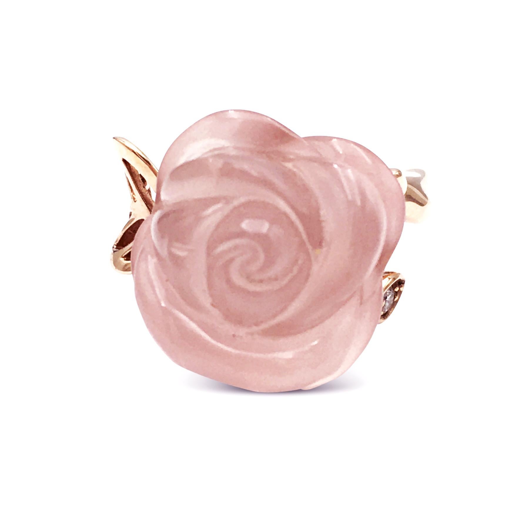 An authentic Christian Dior ring from the Rose Dior Pré Catalan collection. Centering on a hand carved rose quartz stone made to look like a crystalized rose and set with one diamond weighing approximately 0.03 carats. Signed Dior, AU 750. CIRCA