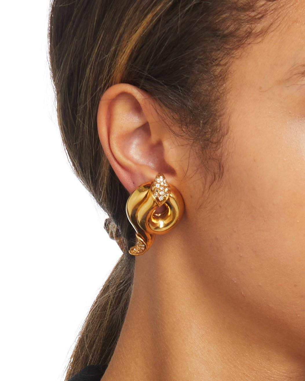 Gorgeous, unique clip-on earrings by Christian Dior.
Each earring resembles a coiled snake, with diamond accents on the head and tail.
Earrings are in good condition. Show few signs of aging or wear.
Featured in Bonhams 