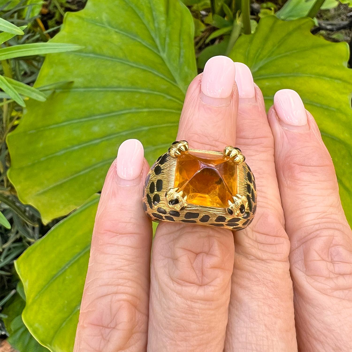 Domed cocktail ring, centering a sugarloaf cabochon-cut citrine set with leopard paw motif prongs, in textured 18k yellow gold decorated with black enamel leopard spots.  Citrine measuring approximately 12.5 x 10.5mm.  Signed 'Christian Dior' '750'